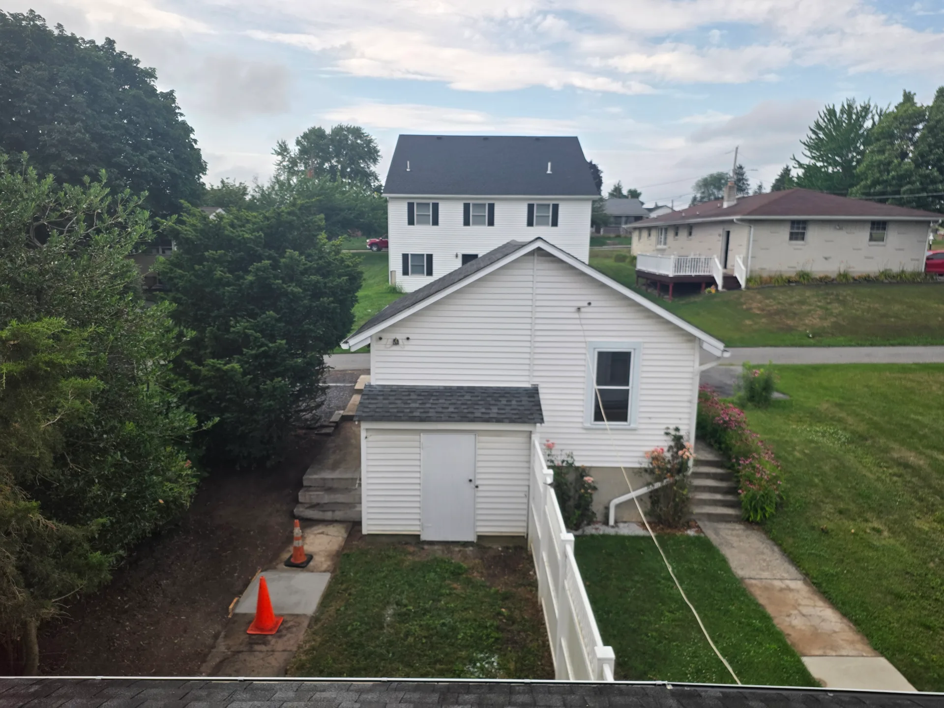Rear exterior showing detached garage and backyard