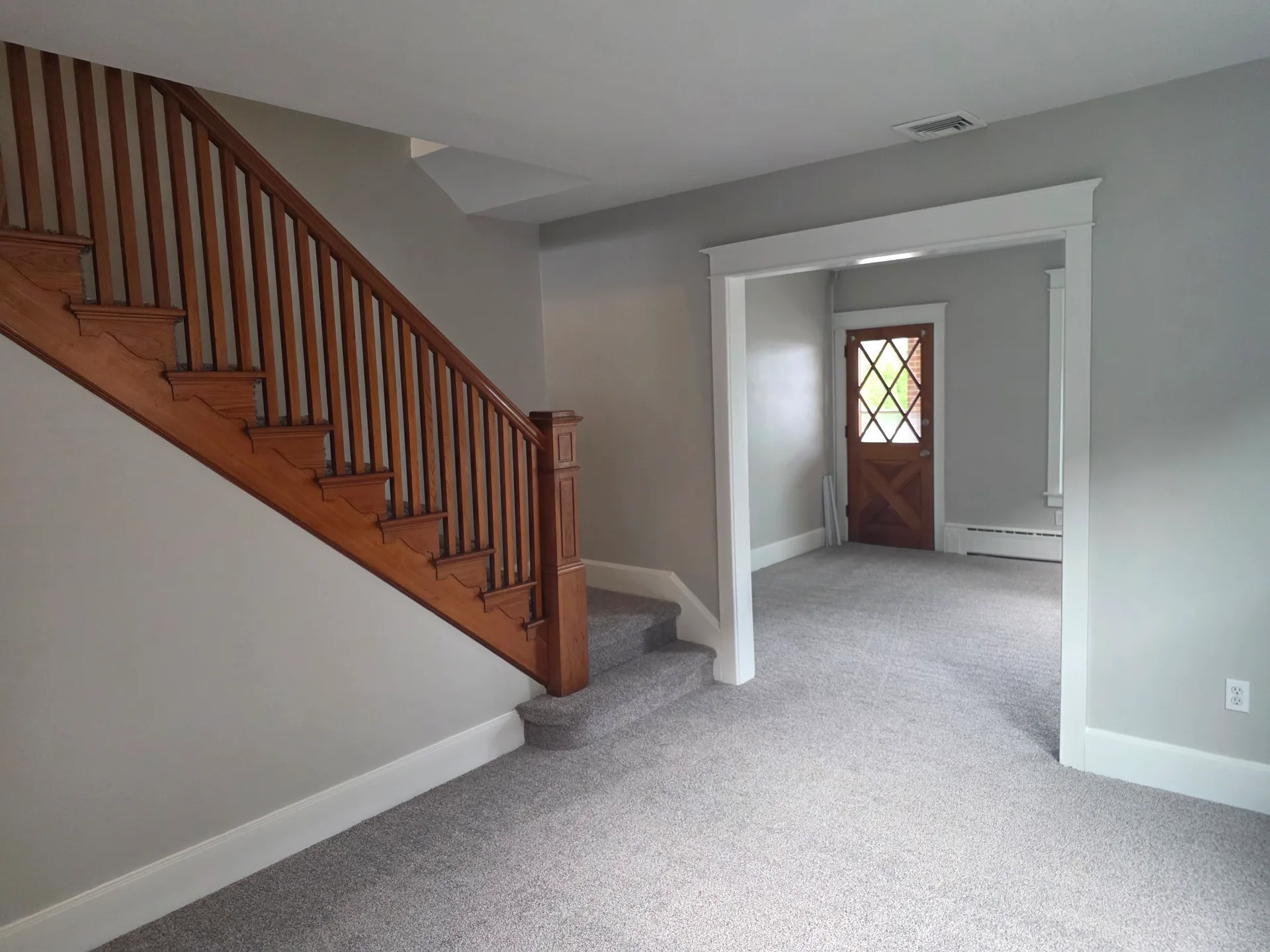 Foyer and staircase with classic wood banister