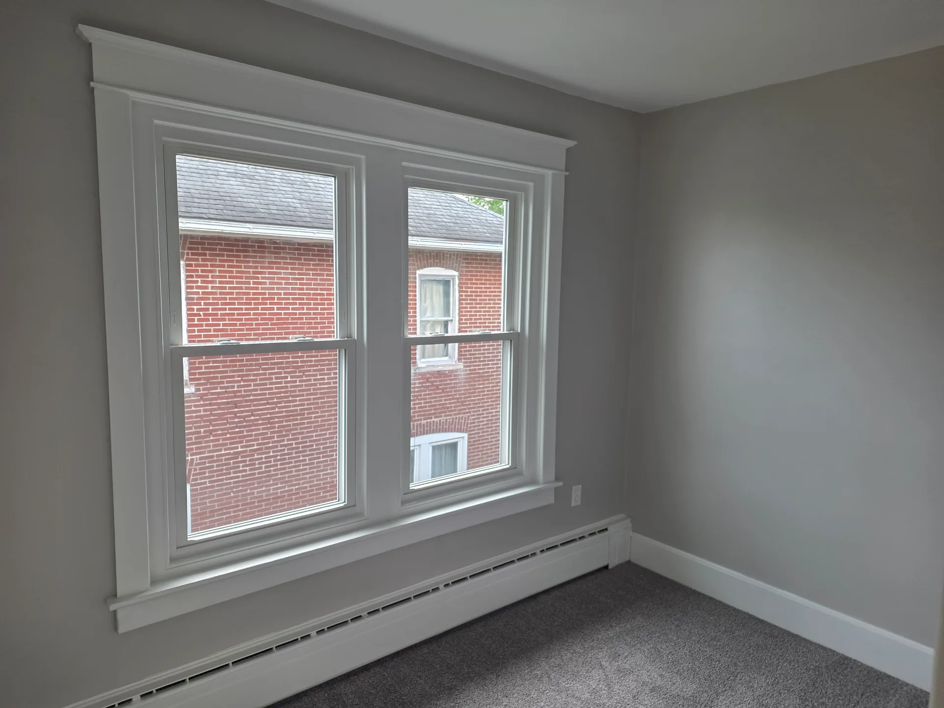 Bedroom with fresh grey paint and new carpeting