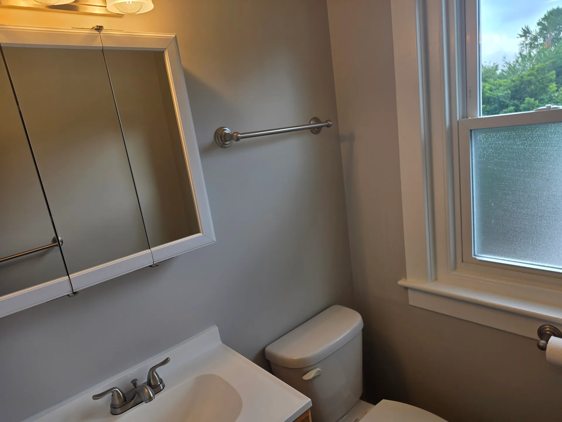 Bathroom vanity with mirrored medicine cabinet and frosted window