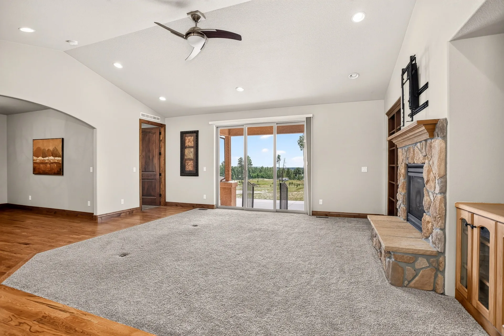 Living room with fireplace, recessed lighting, and sliding doors