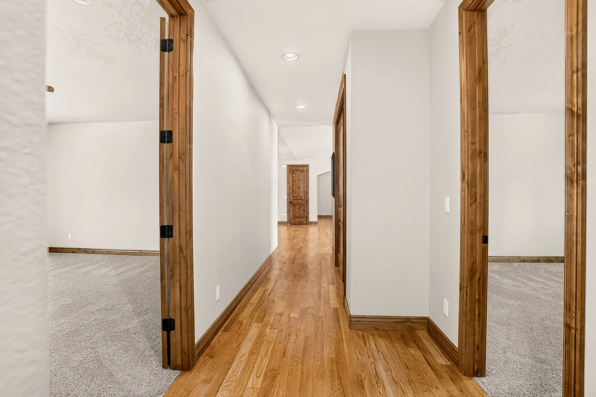Interior hallway with wood trim and hardwood floors