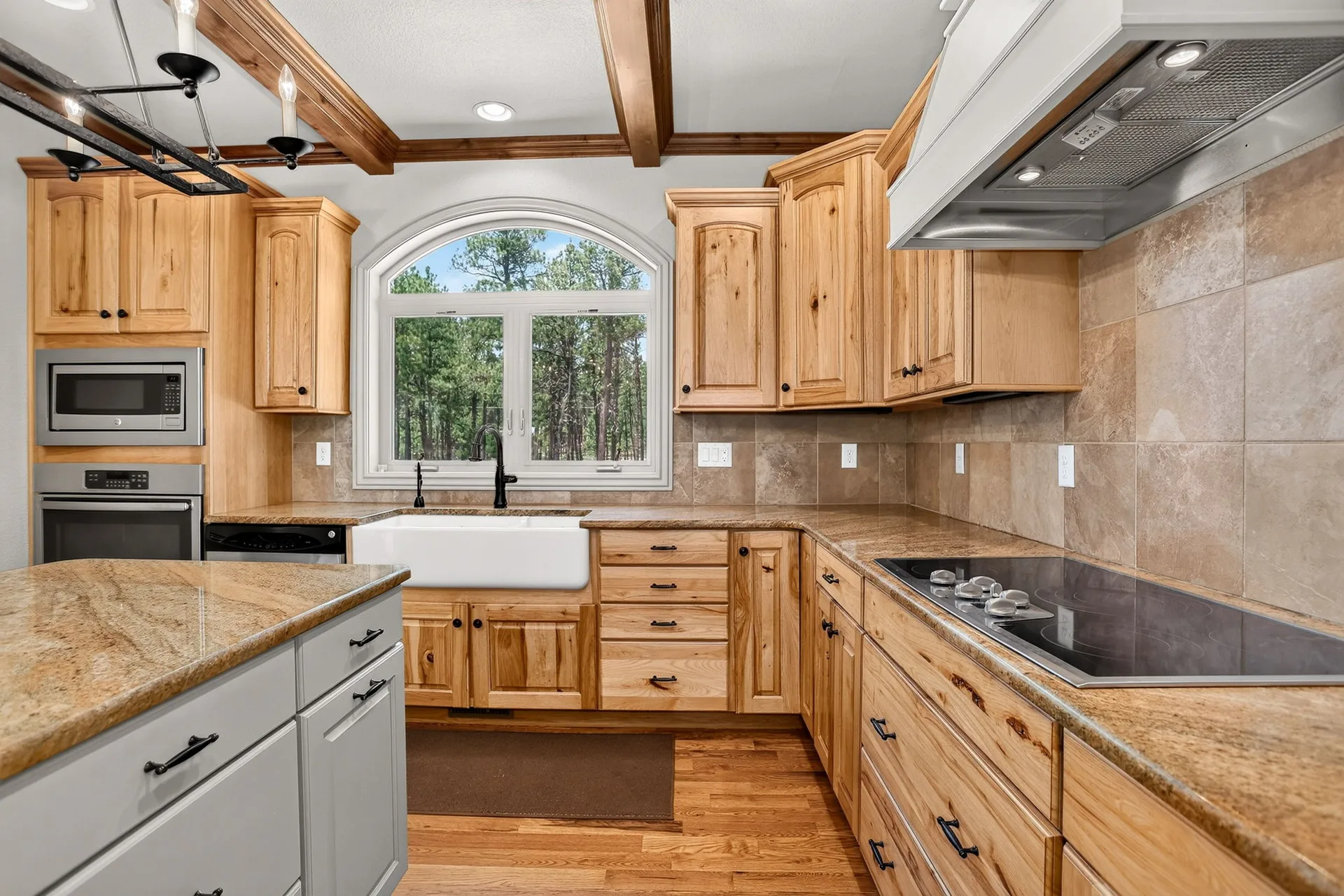 Kitchen with knotty alder cabinetry and ceiling beams