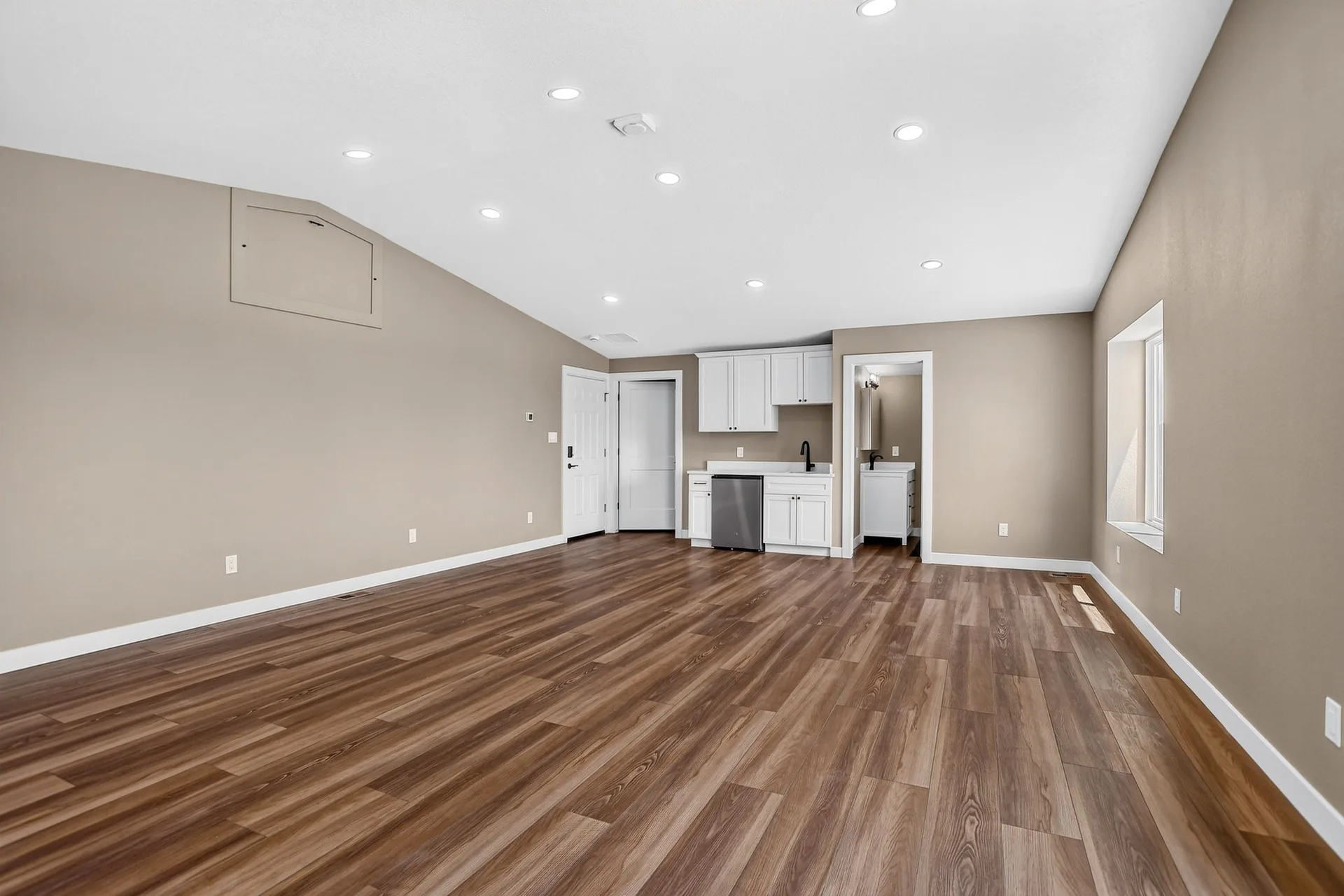 Open lower-level living space with kitchenette