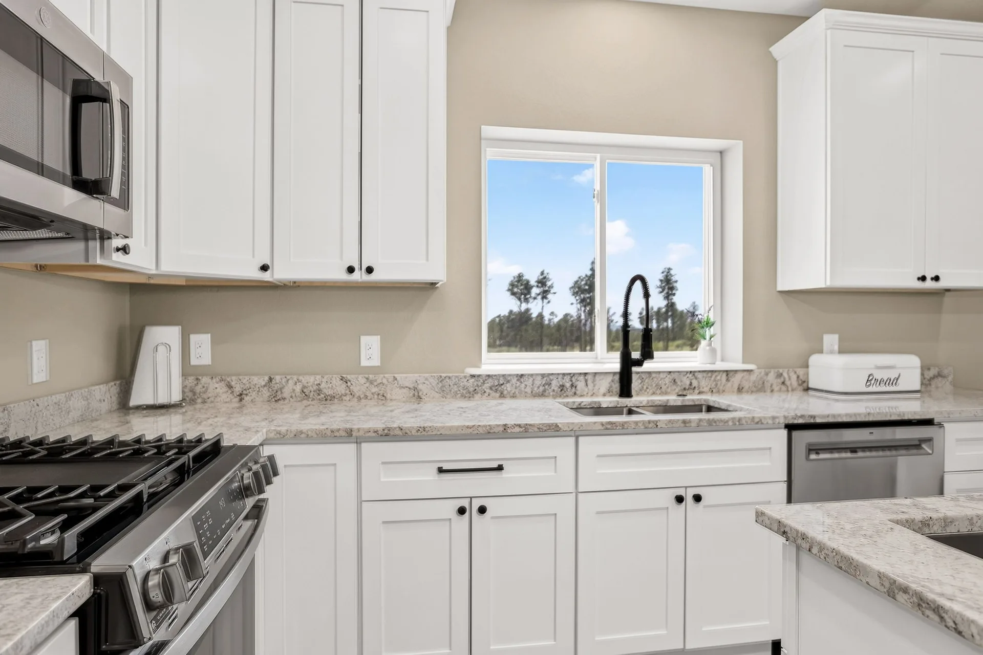 White shaker kitchen cabinets with granite countertops