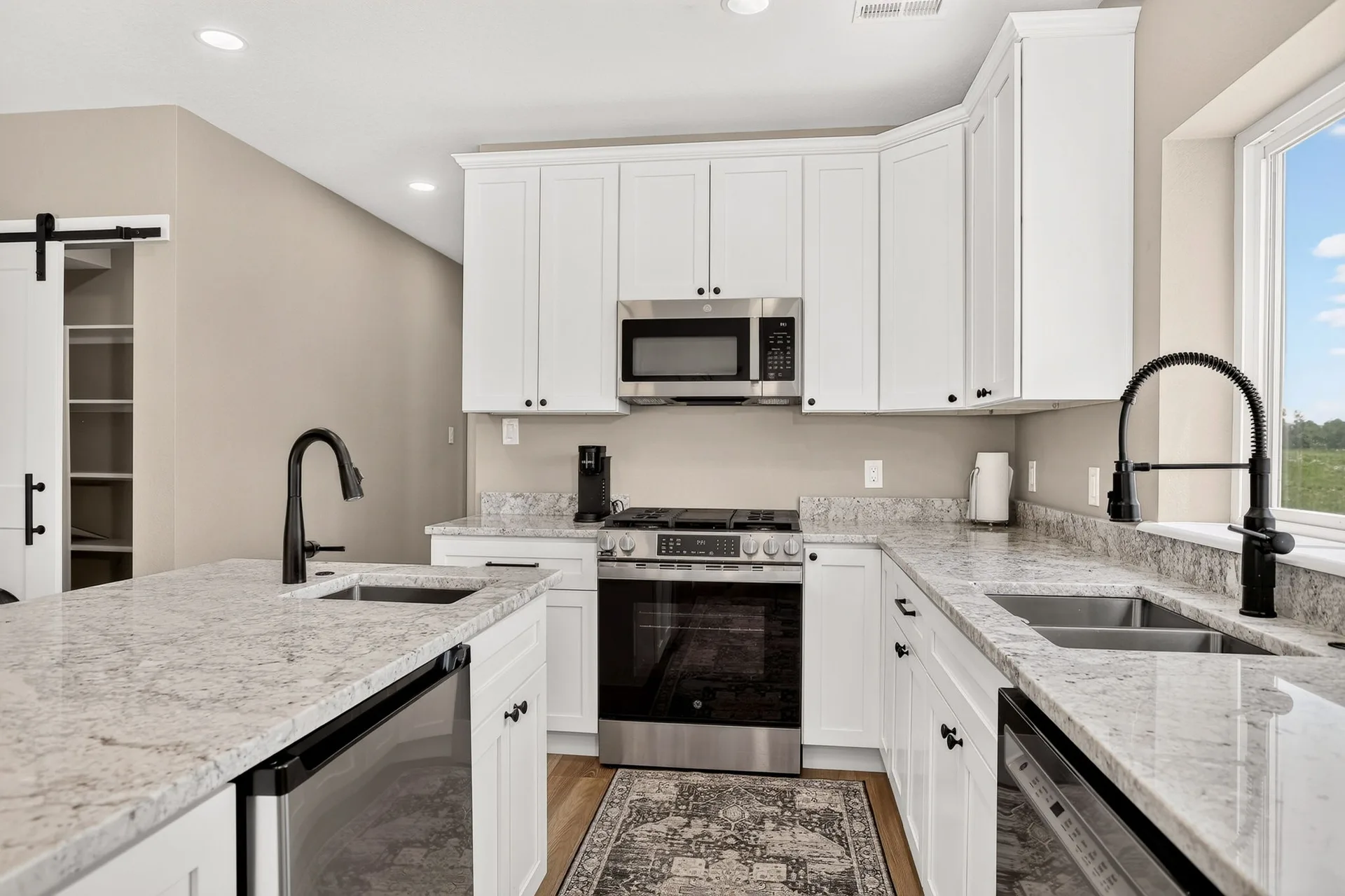 Modern kitchen with white cabinets and stainless steel appliances