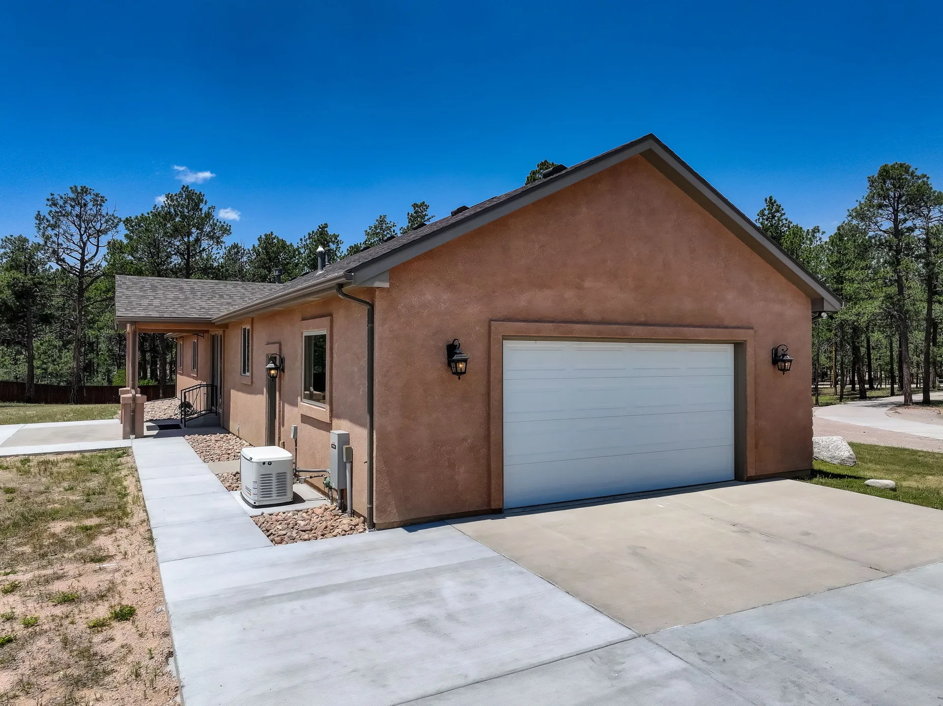Side view showing garage and HVAC units