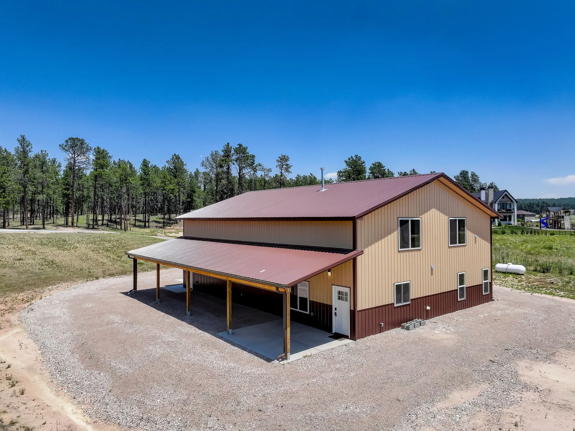 Pole barn style detached building with wrap-around porch