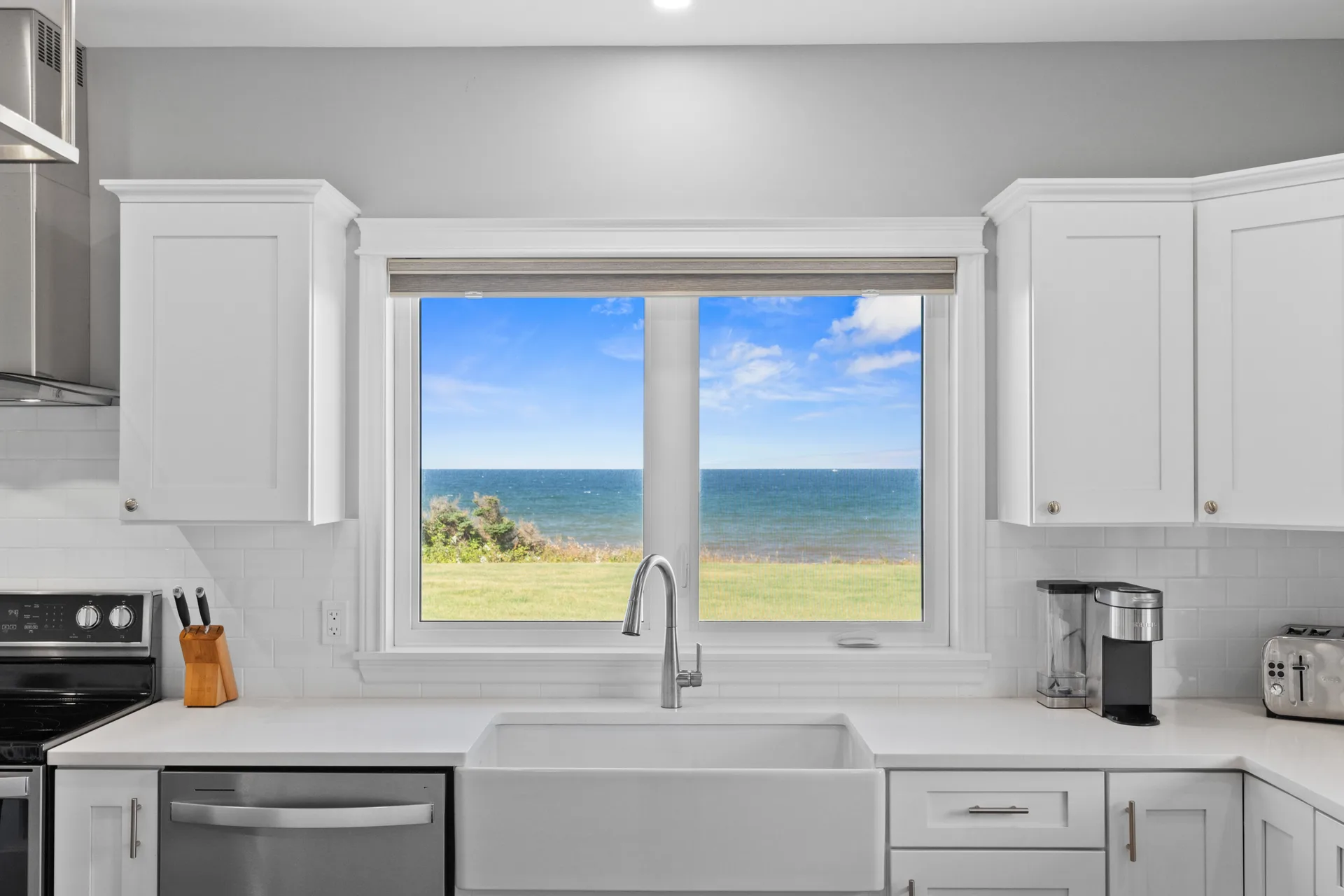 Gourmet kitchen with farmhouse sink and ocean view