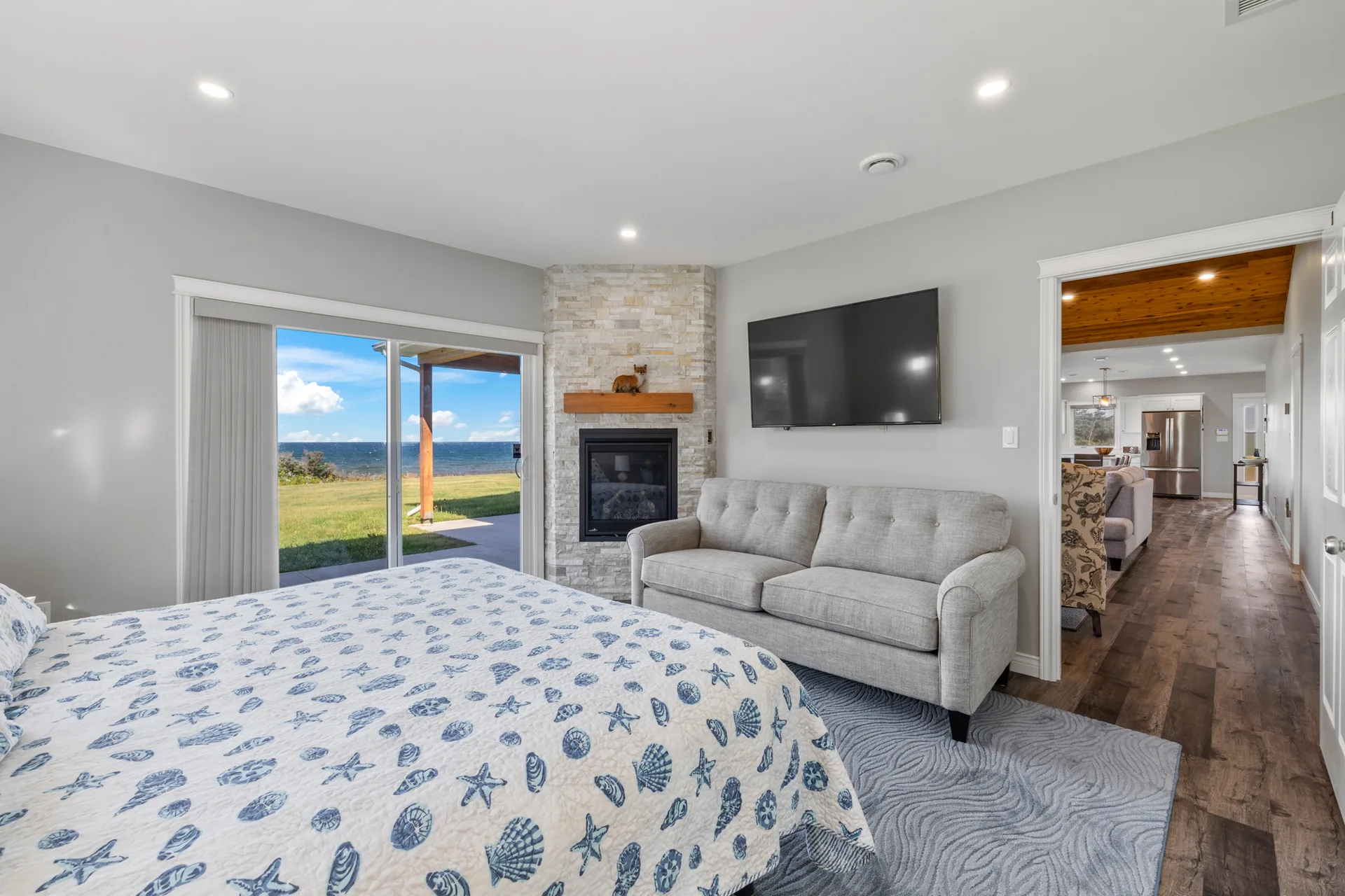 Primary suite with stone fireplace and ocean view