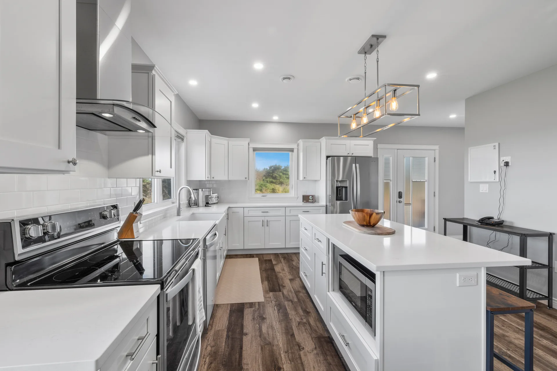 Gourmet white kitchen with island and stainless steel appliances