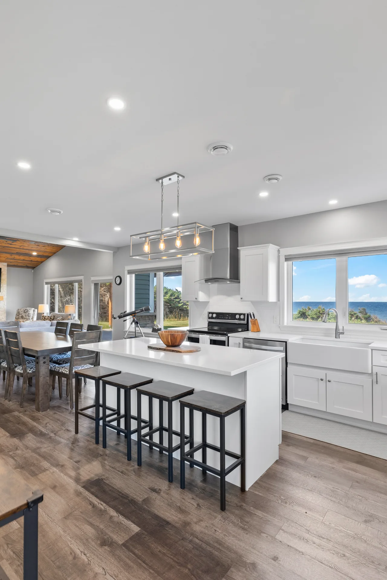 Kitchen and dining with water views through large windows