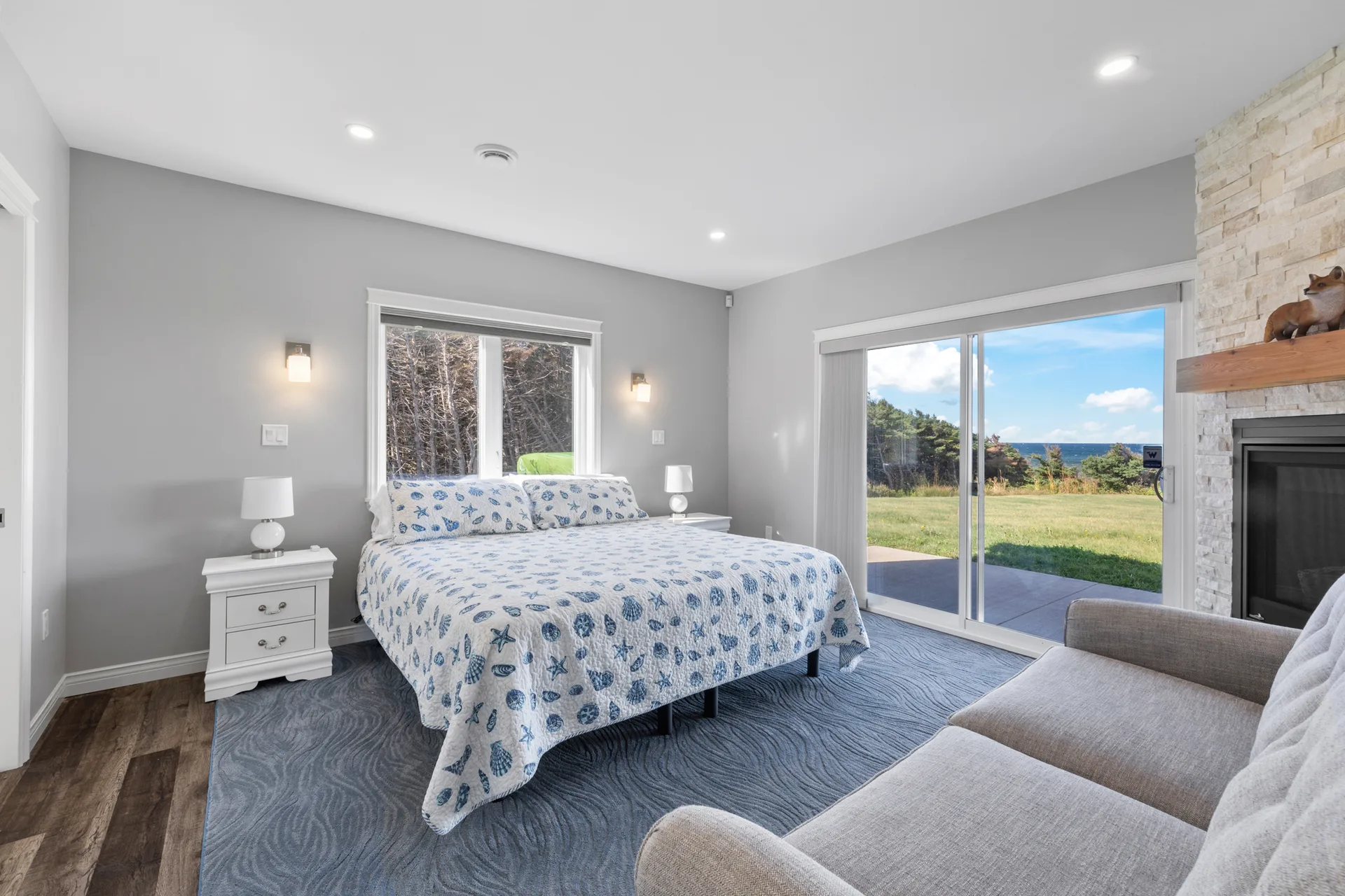 Primary bedroom with stone fireplace facade