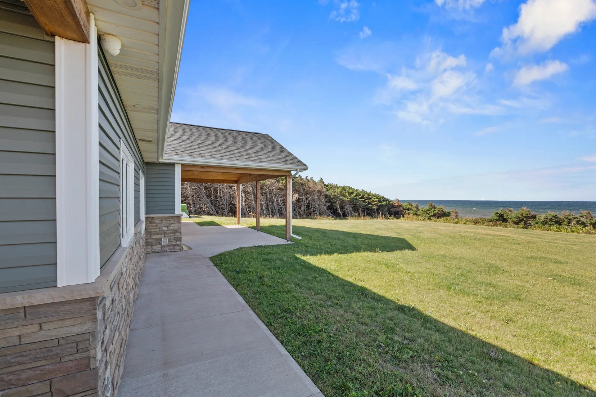 Backyard side patio with ocean view in distance