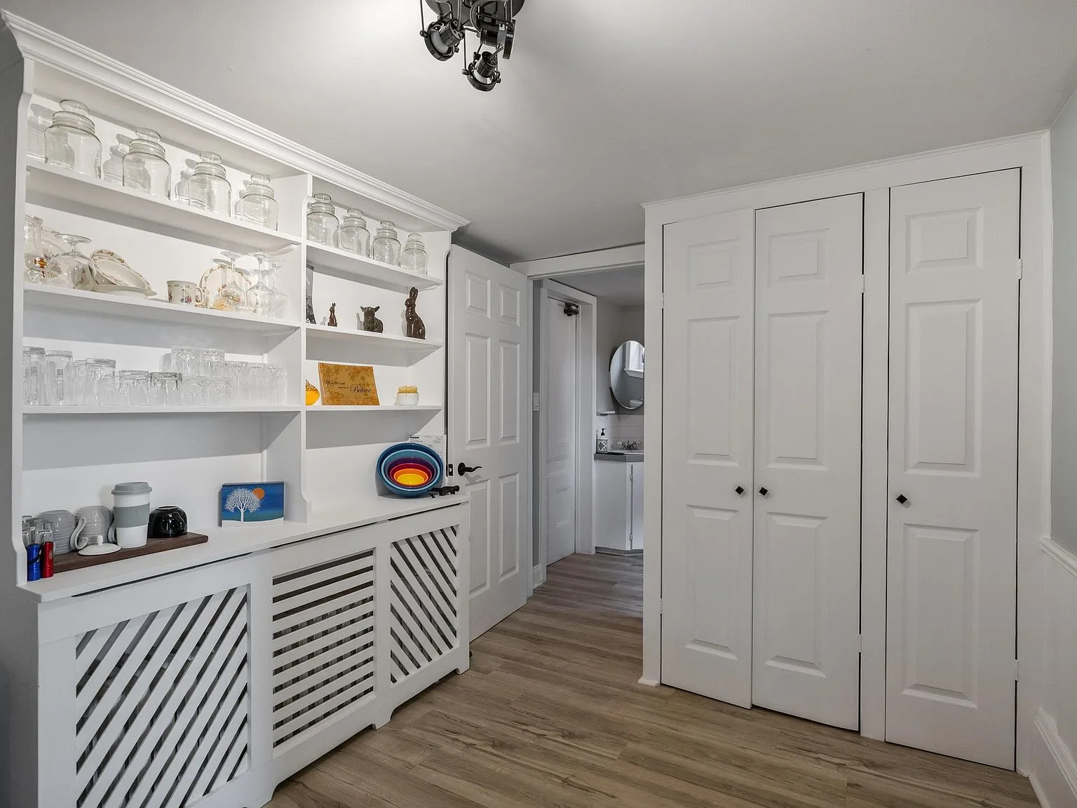 Hallway with white built-in cabinetry and open shelving