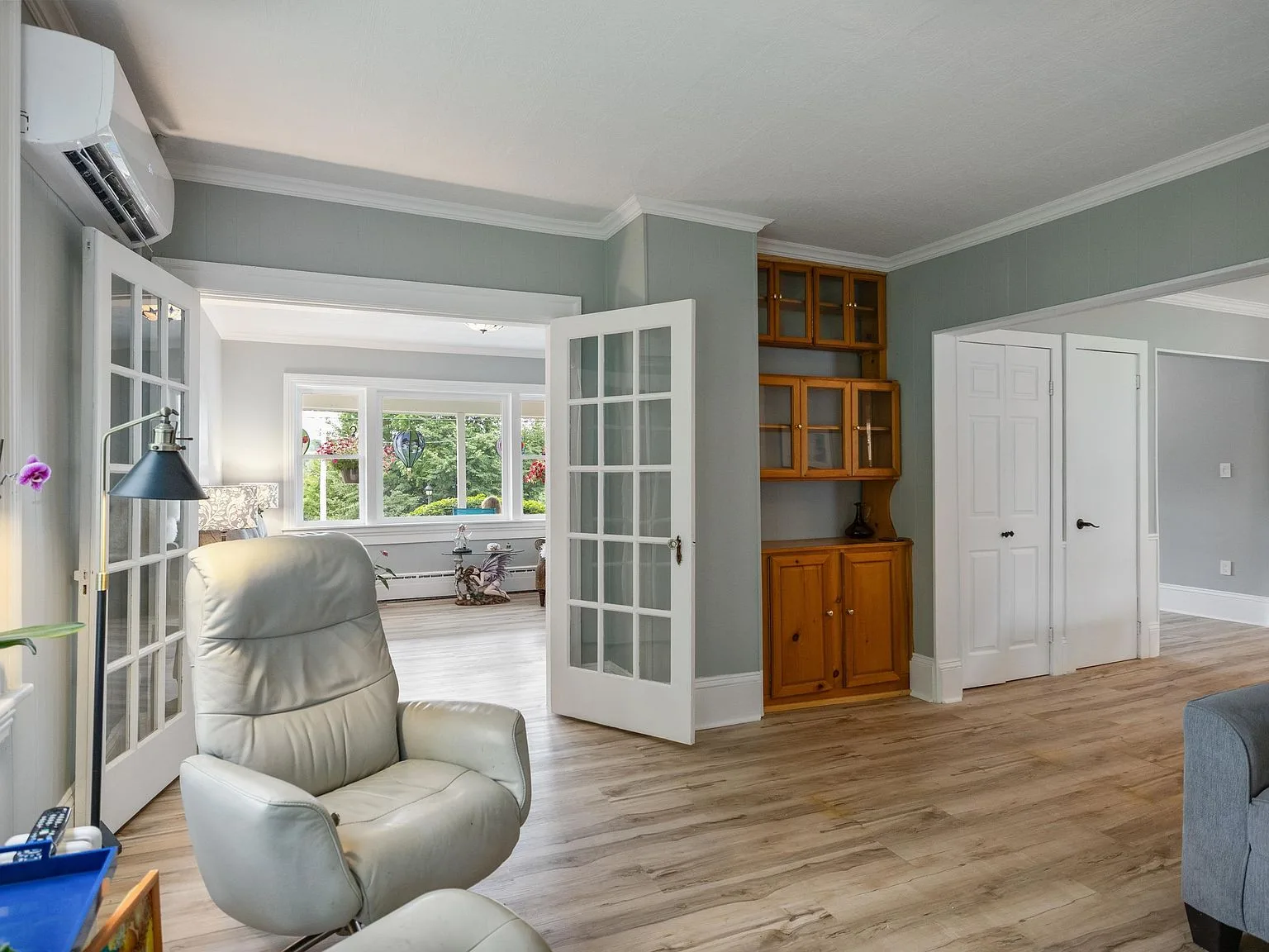 Living room looking through French doors into an adjacent room