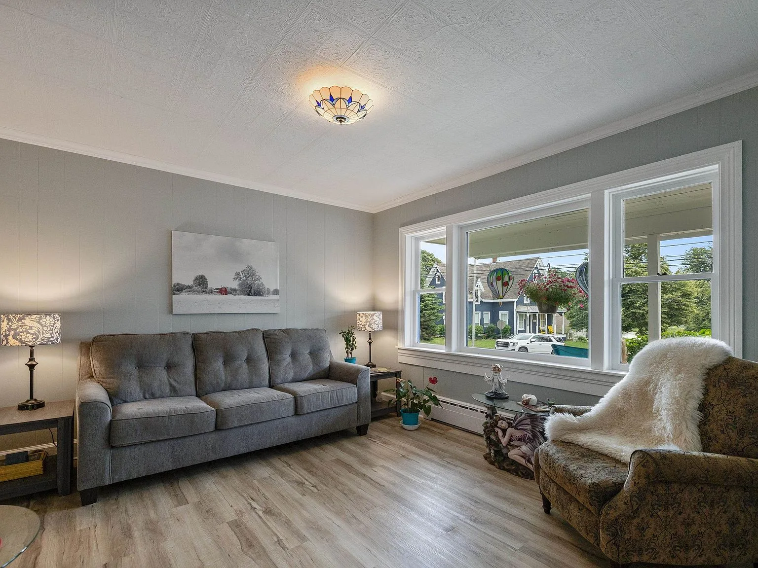 Bright living room with large windows overlooking the River Clyde