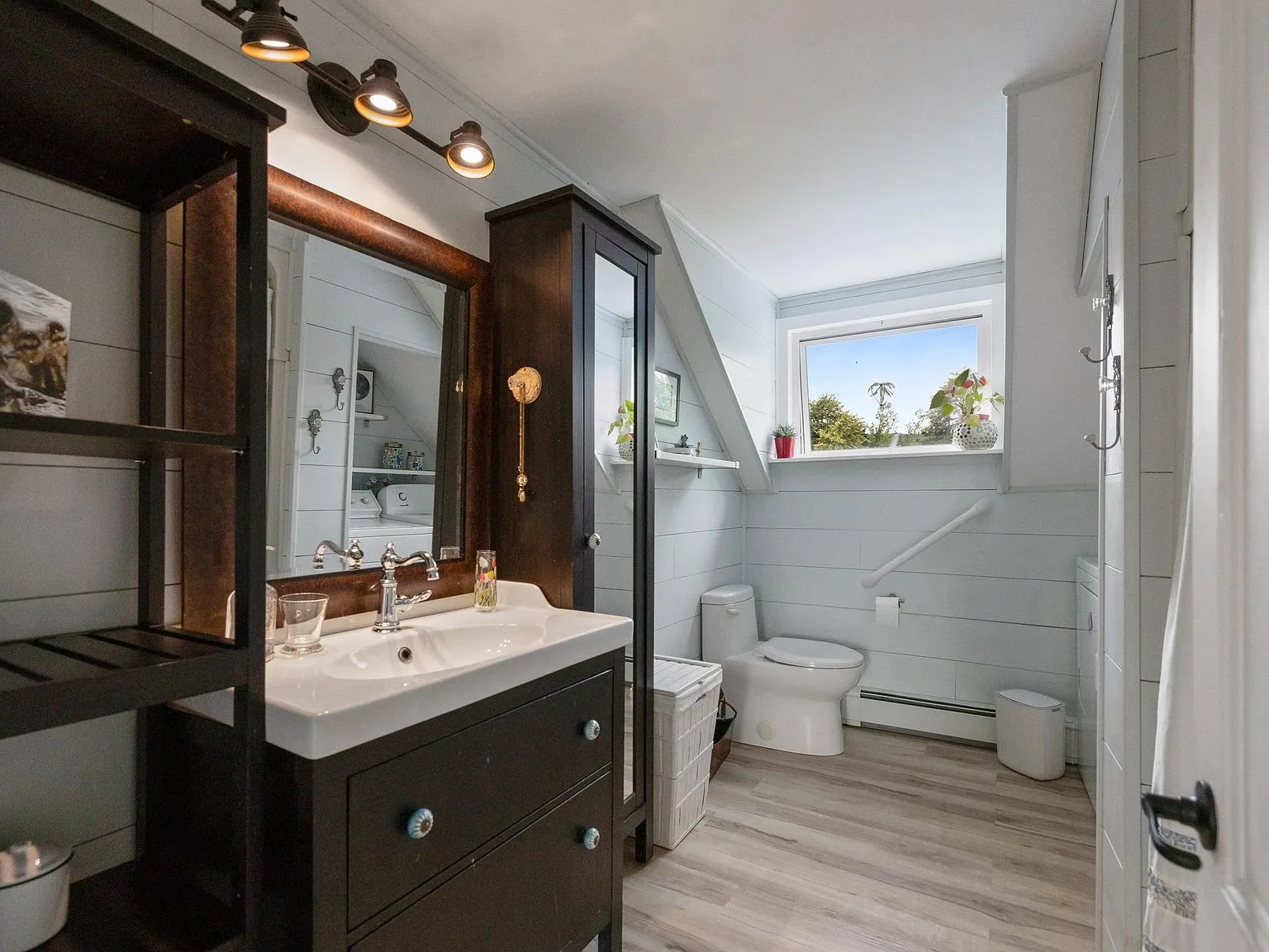 Bathroom with horizontal shiplap walls and dark wood vanity