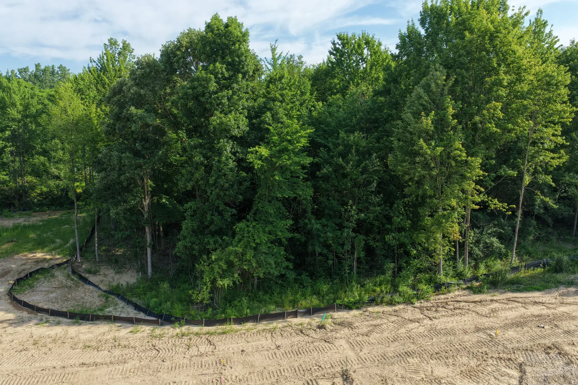 Elevated drone shot of the wooded development site at Oaks of Tyrone showing multiple homesites within the forest