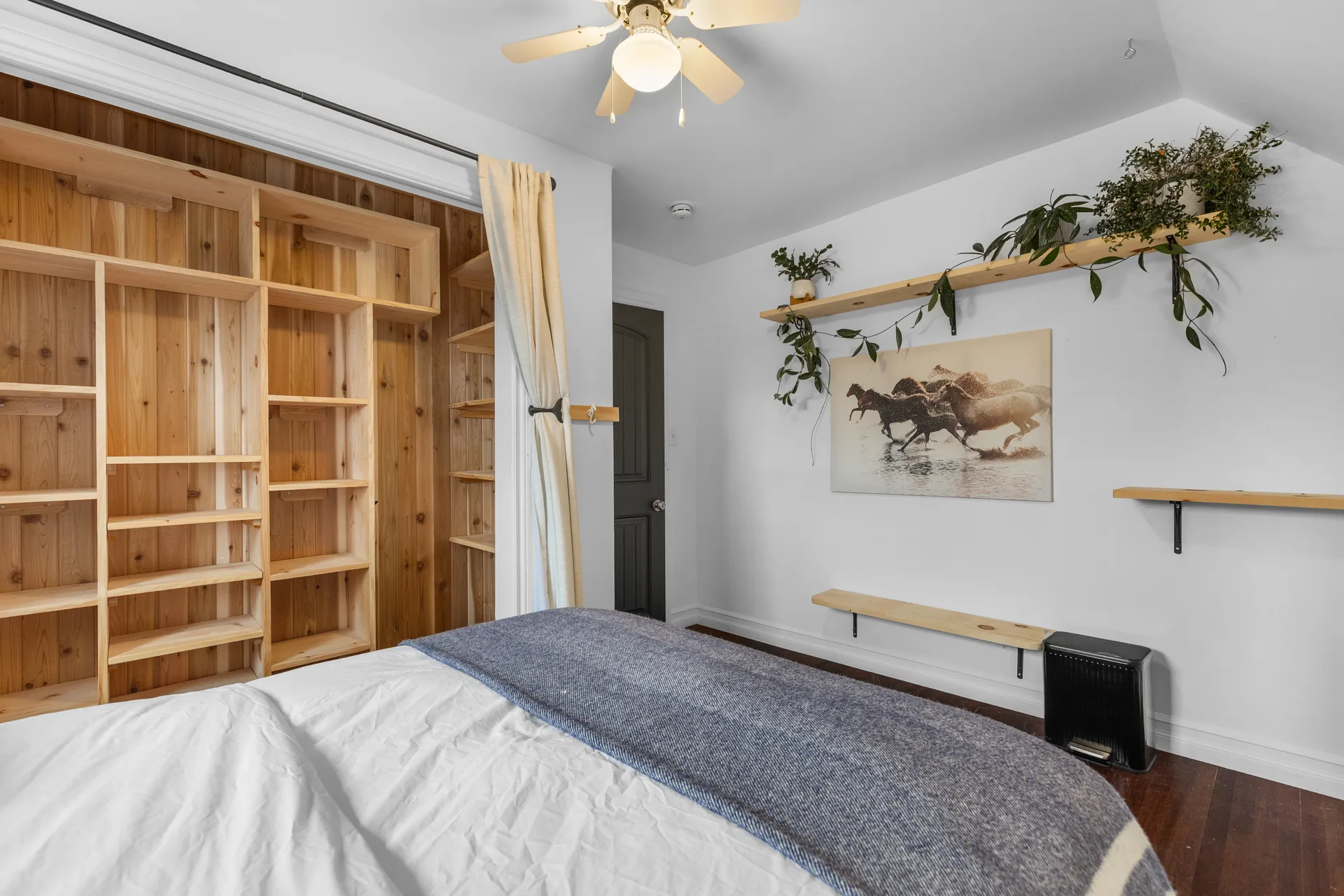 Bedroom with natural wood paneling features and farmhouse character