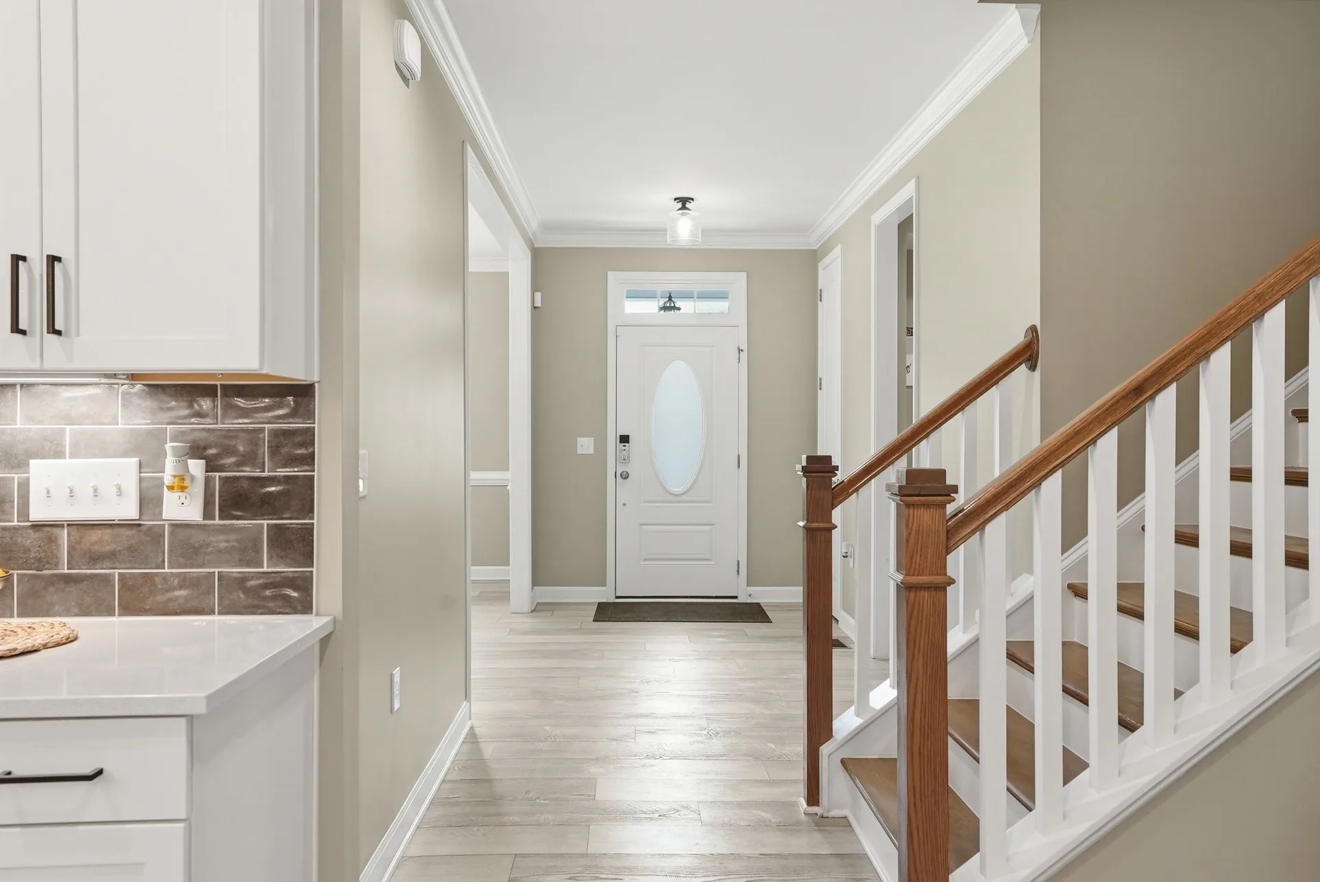 Entryway with staircase and luxury vinyl plank flooring