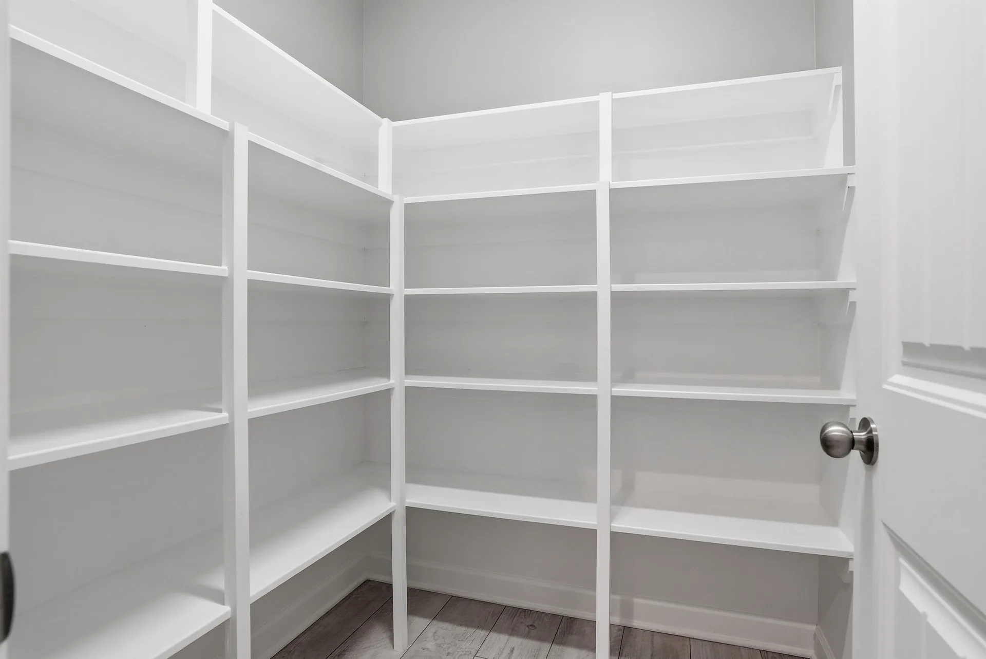 Walk-in pantry with built-in white shelving