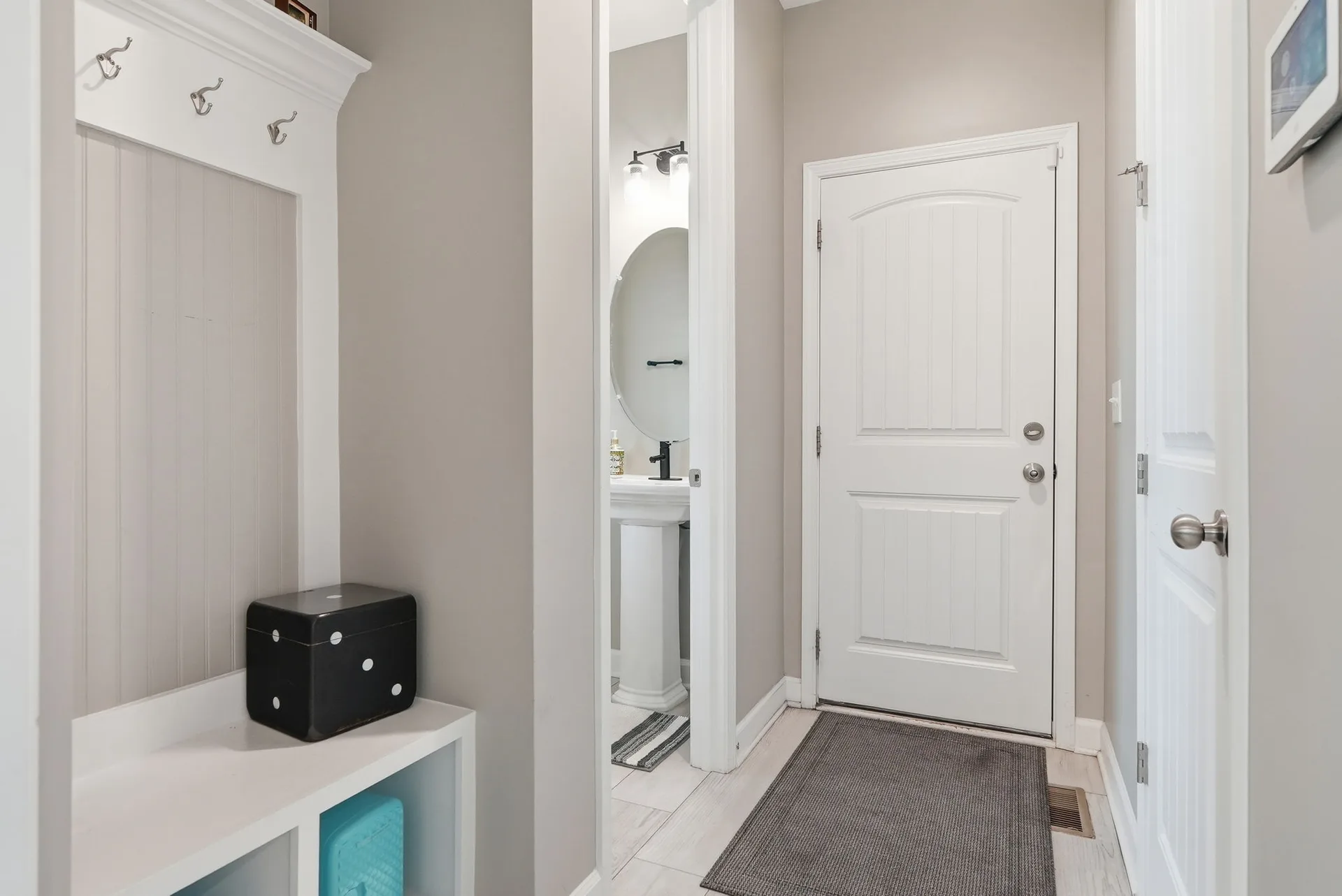 Mudroom entry with built-in storage and powder room