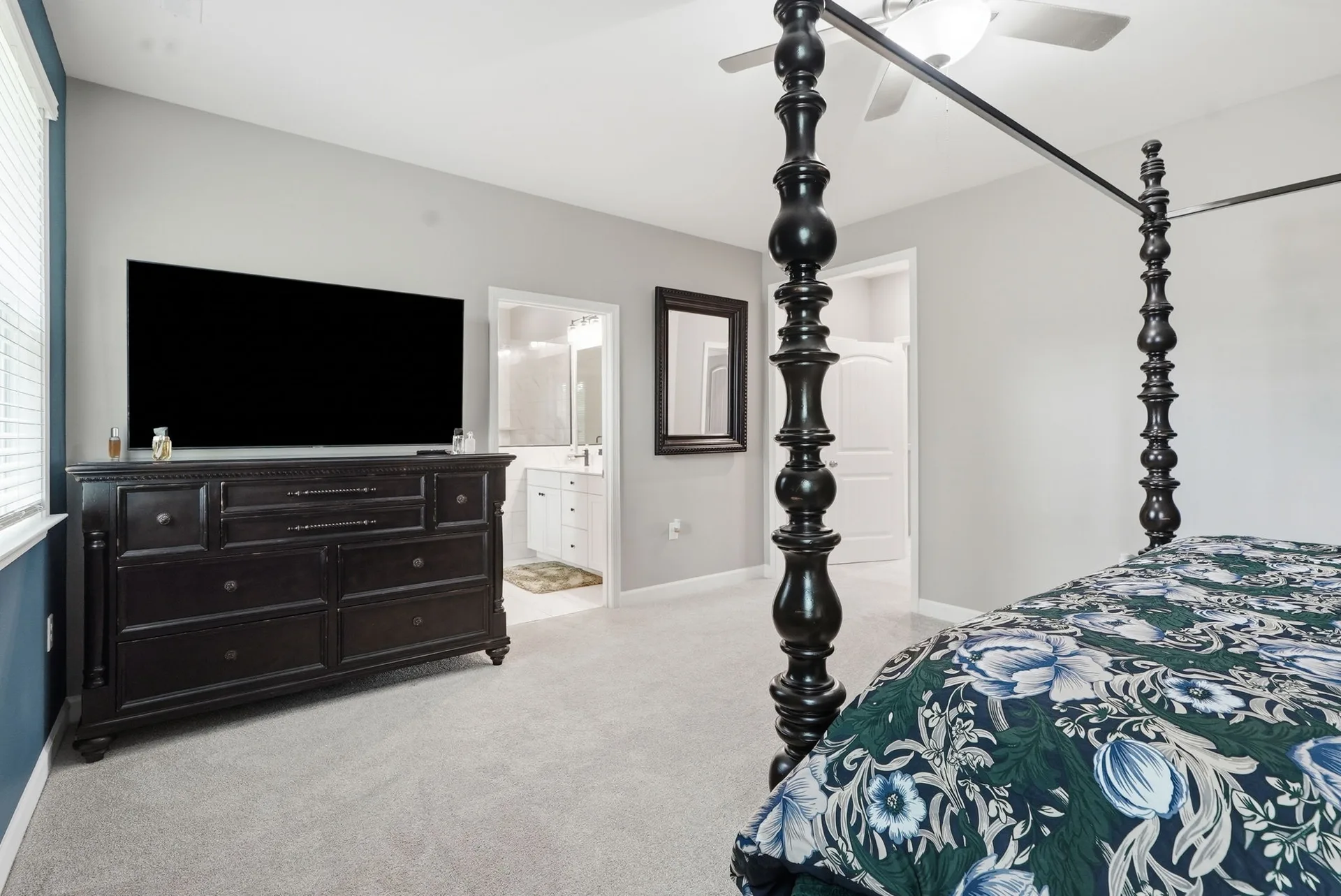 Primary bedroom with dark wood furniture