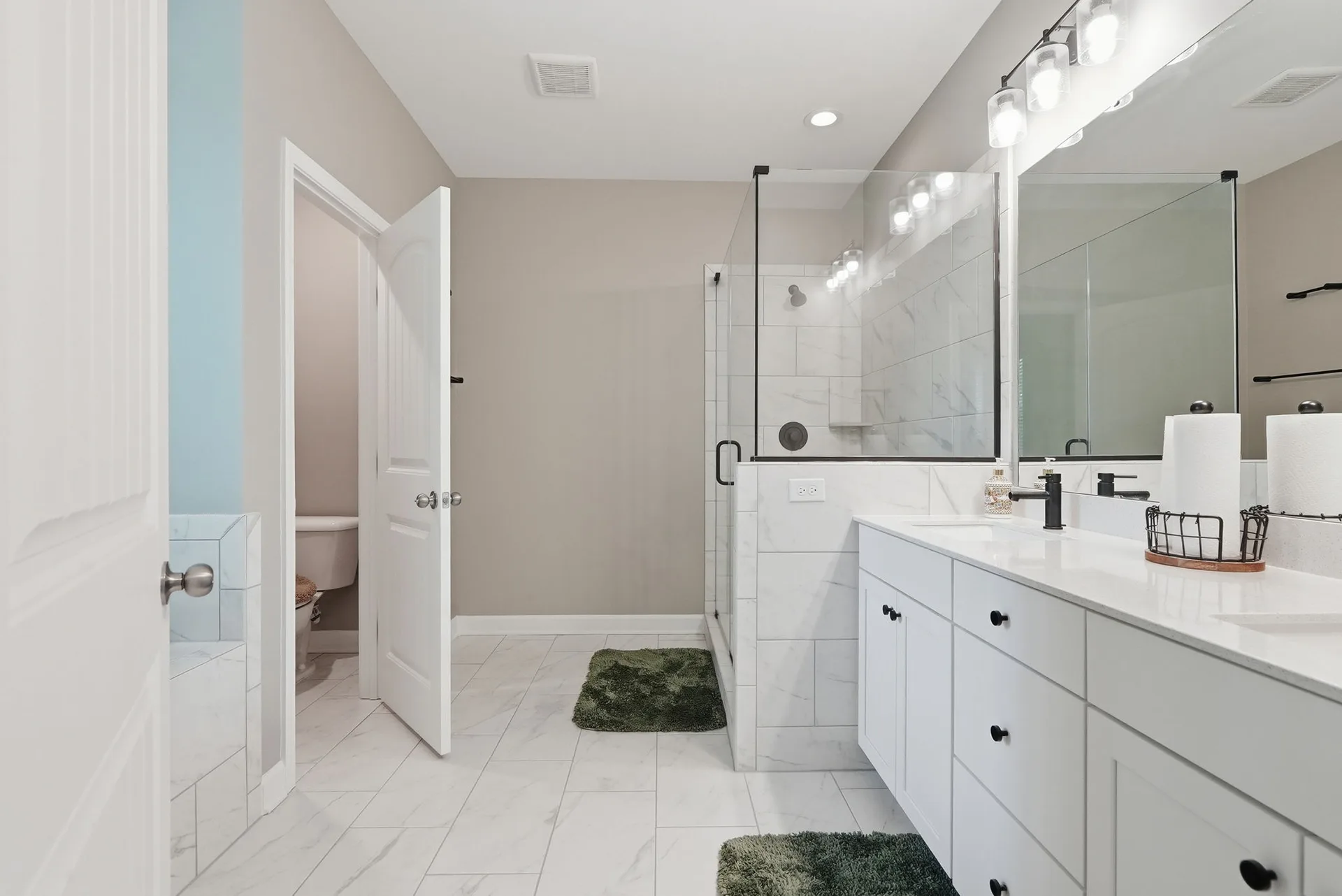 En-suite bathroom with dual vanity and glass shower
