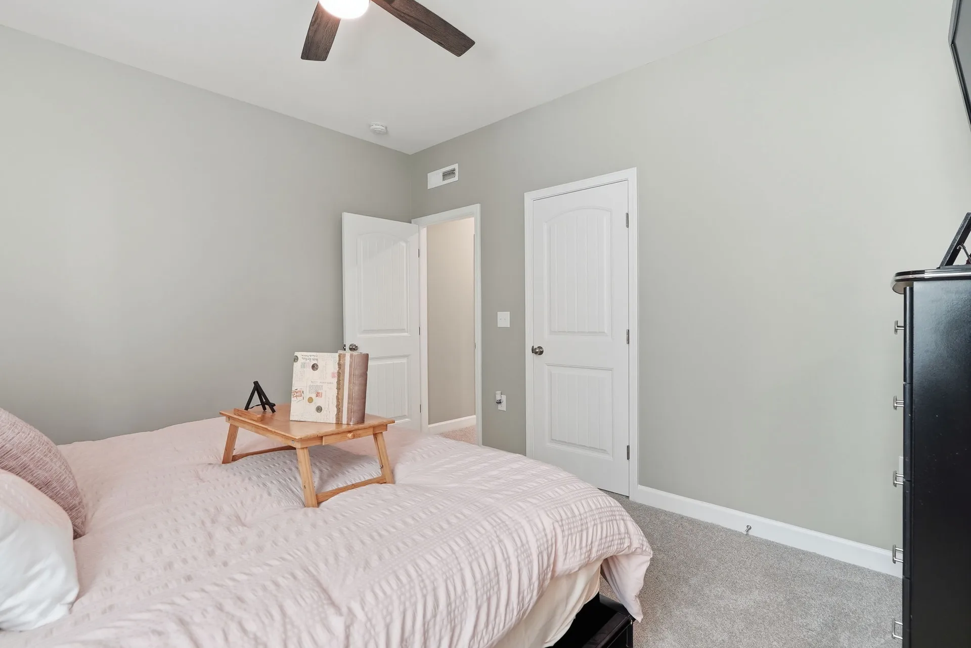 Secondary bedroom with grey walls and carpet