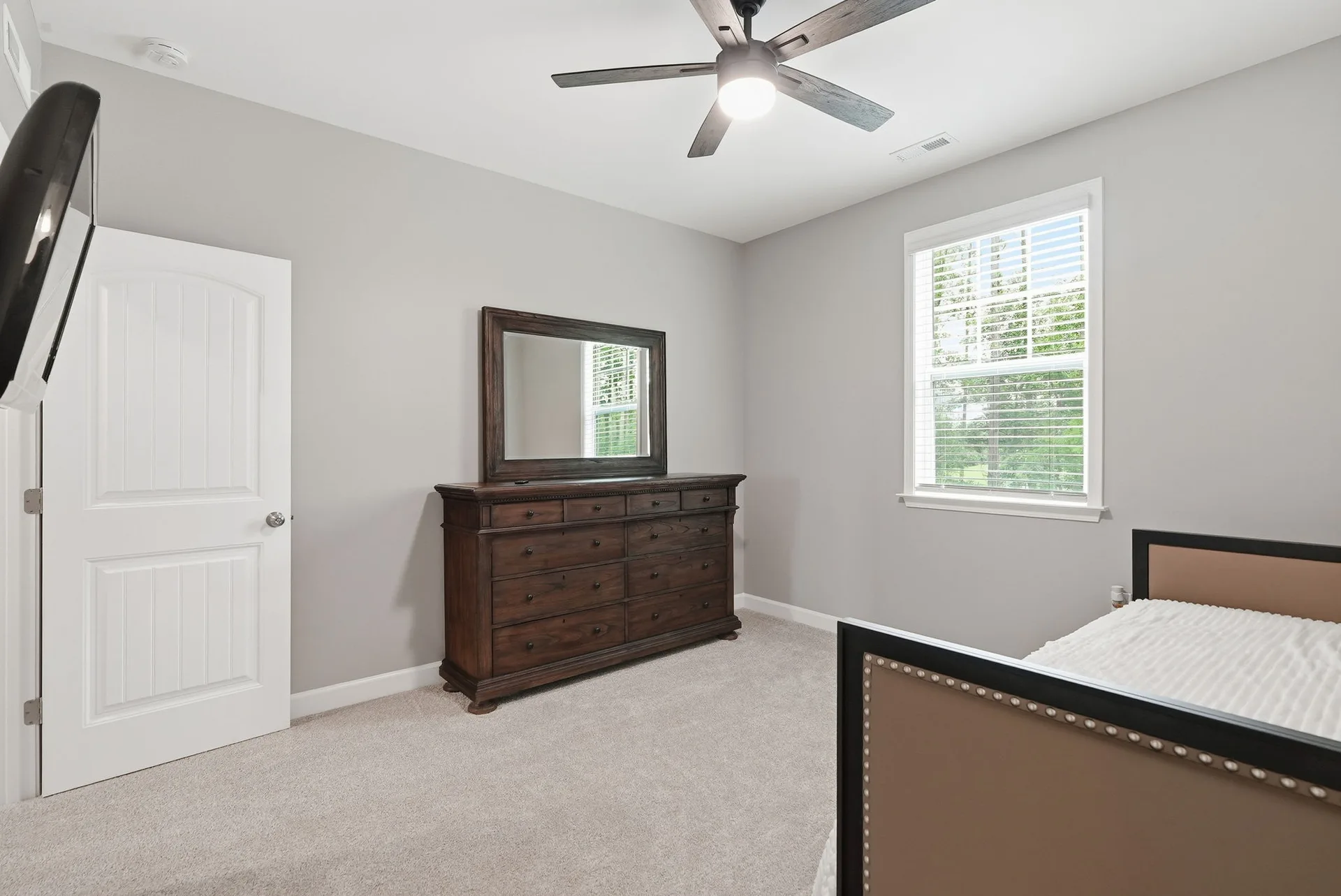 Second bedroom with beige carpeting