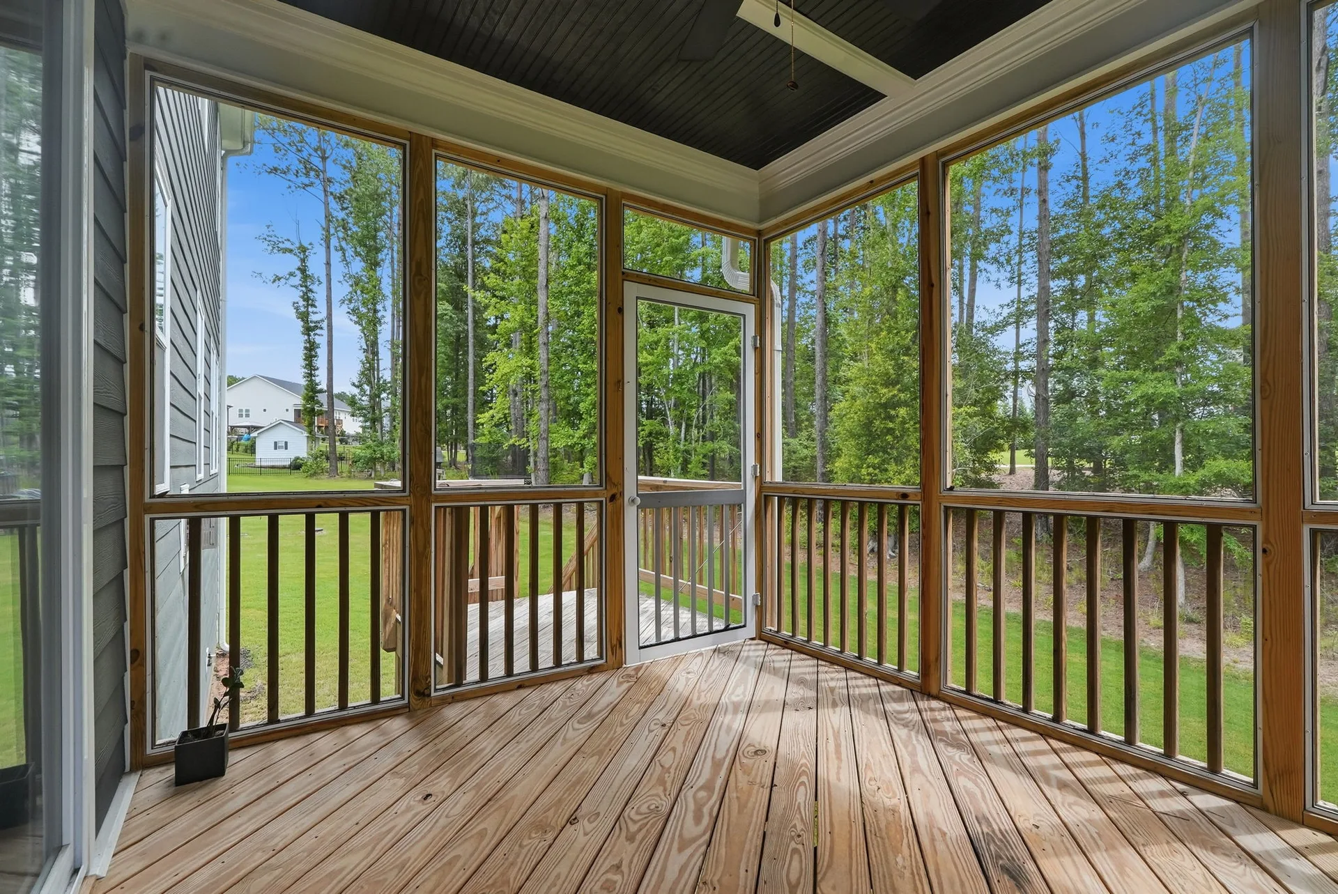 Interior of screened porch with ceiling fan