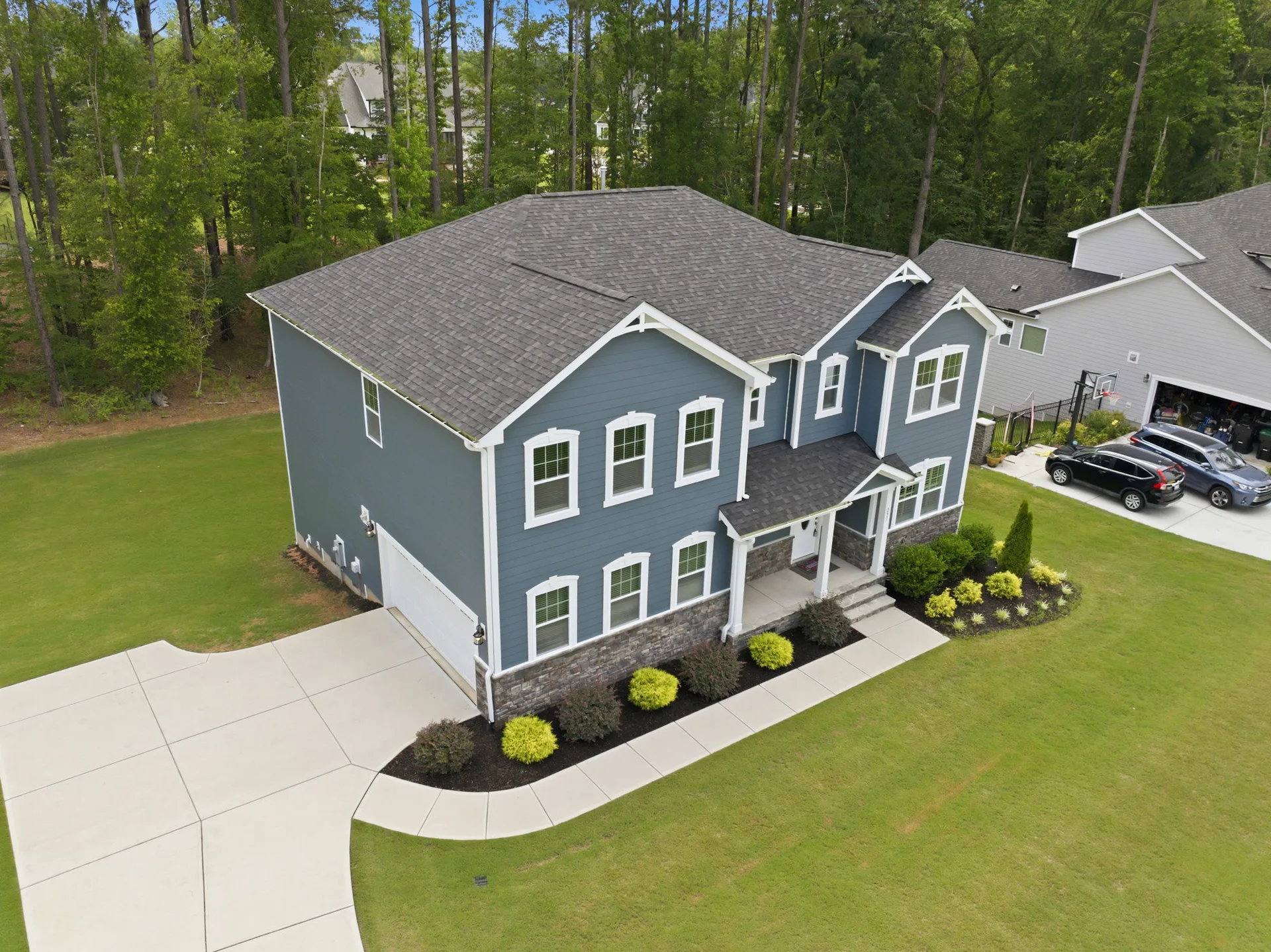 Wide aerial view of the home and surrounding lot