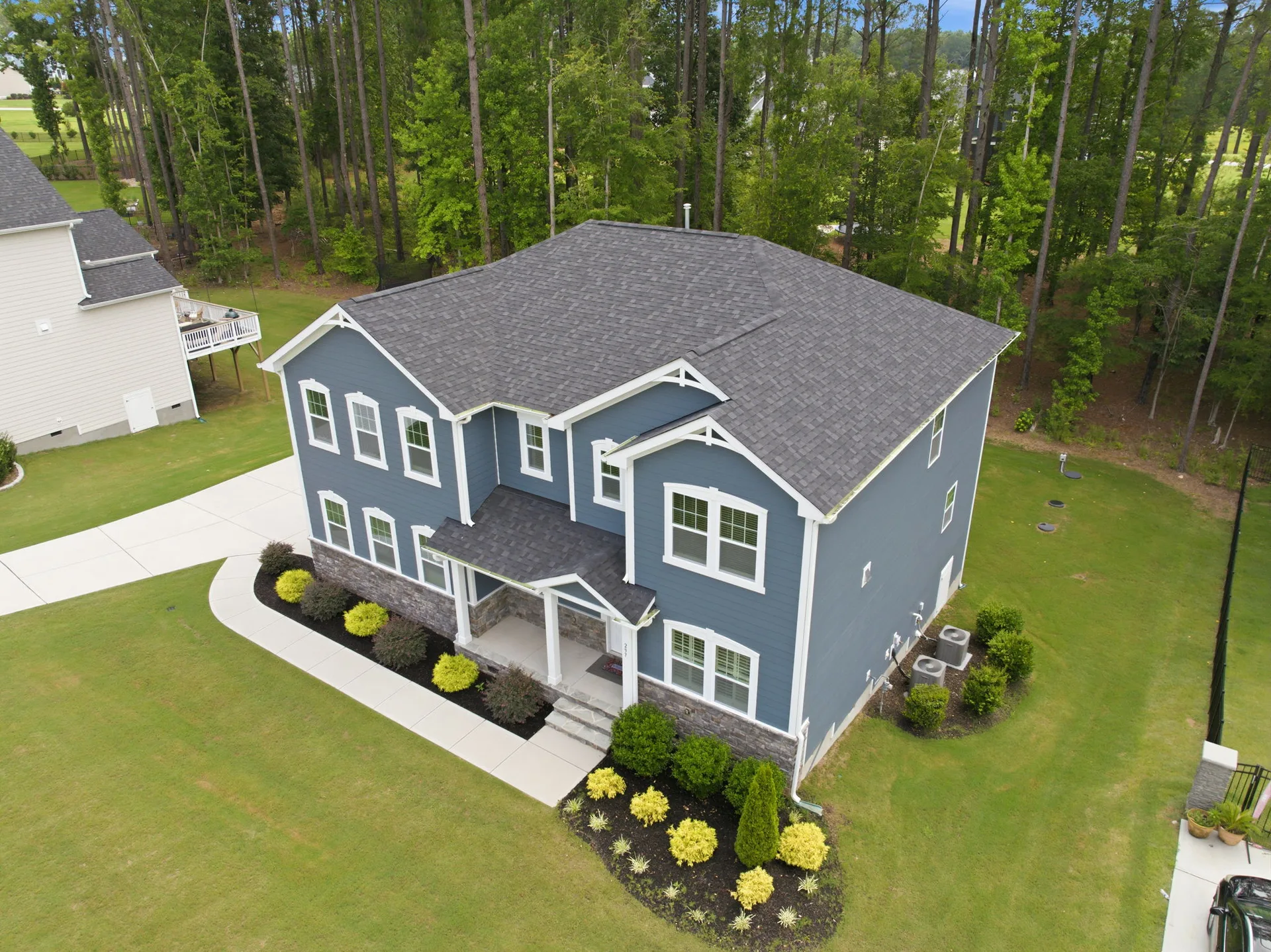Drone view showing the full property and mature trees