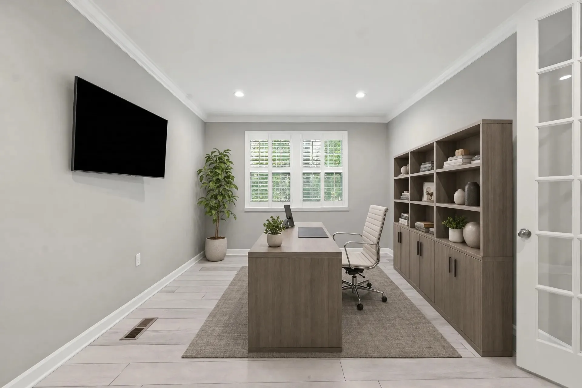 Home office with built-in shelving and French doors