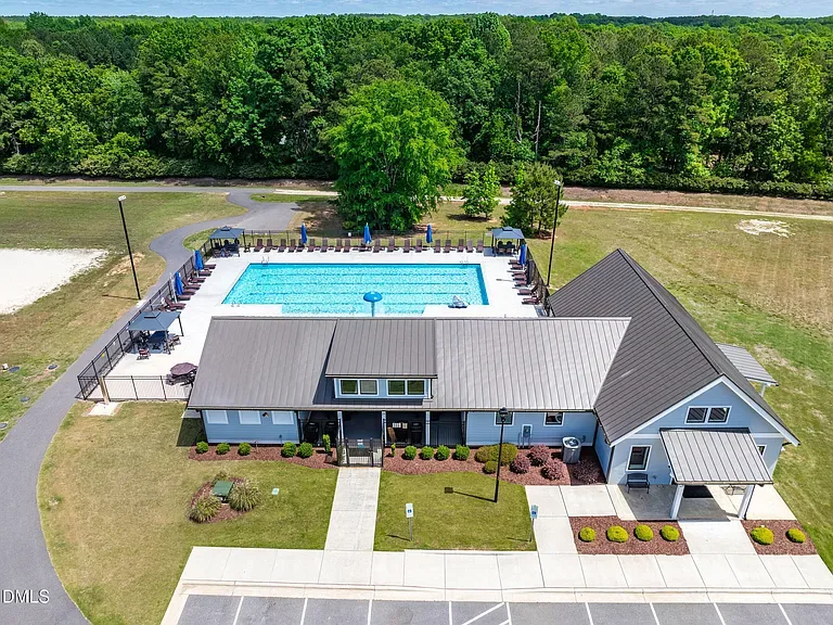Pool house with blue siding and metal roof