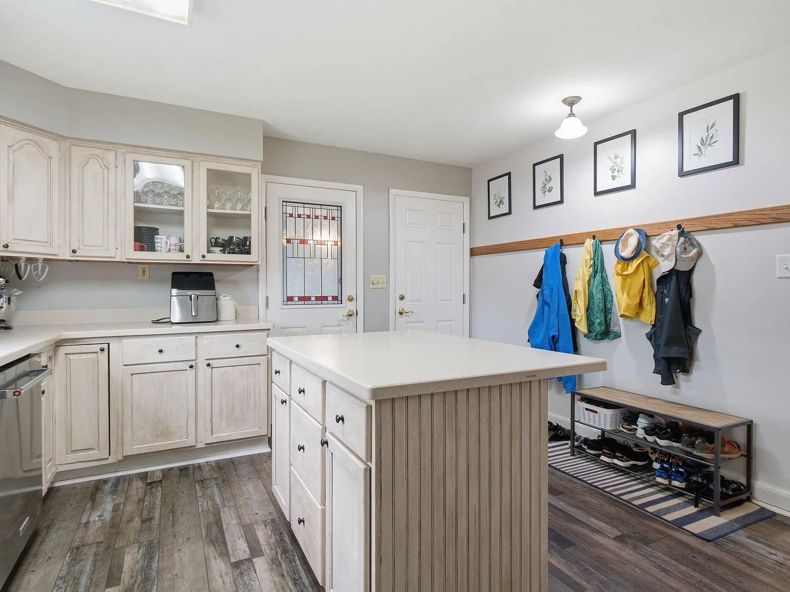 Kitchen entry area with white-washed cabinetry and island
