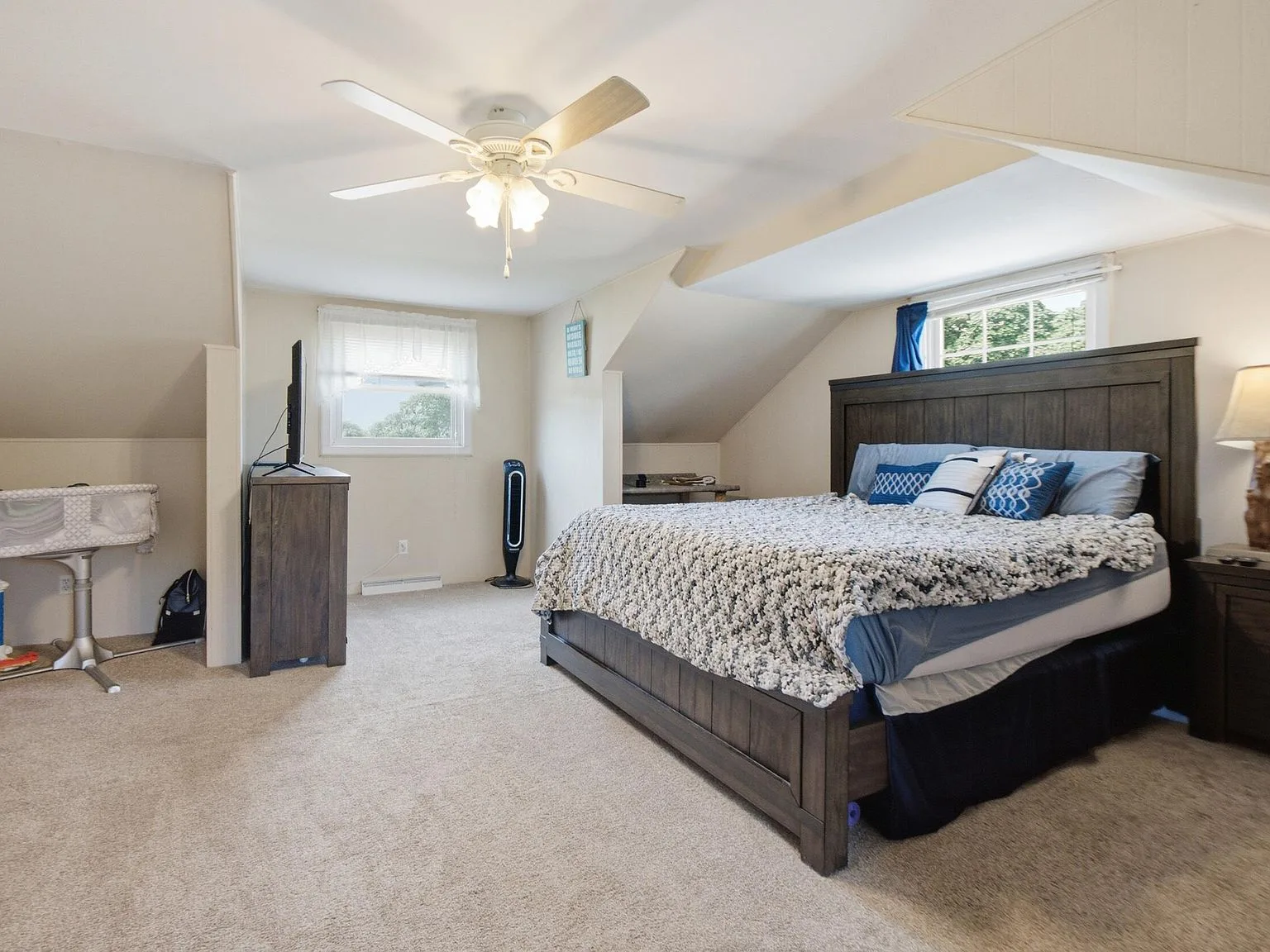 Master bedroom with vaulted ceiling and natural light
