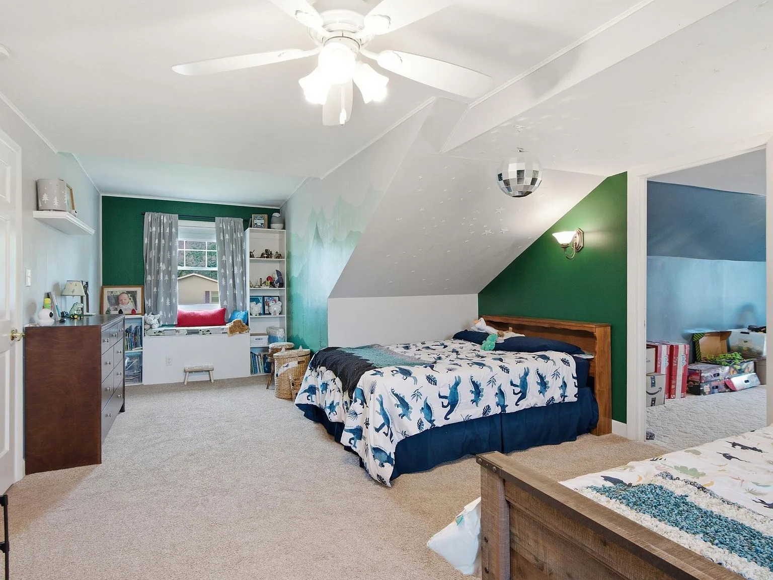 Bedroom with slanted ceiling and green accent wall