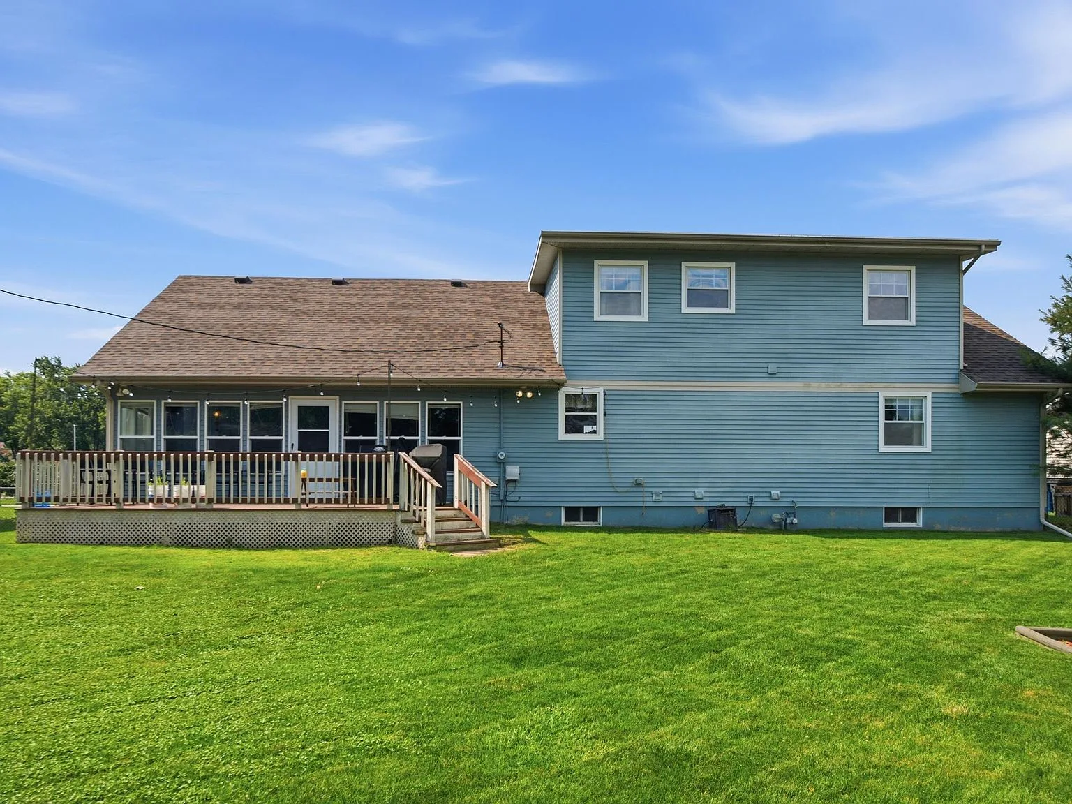 Rear facade of 954 Mohawk Dr showing the backyard, deck, and sunroom