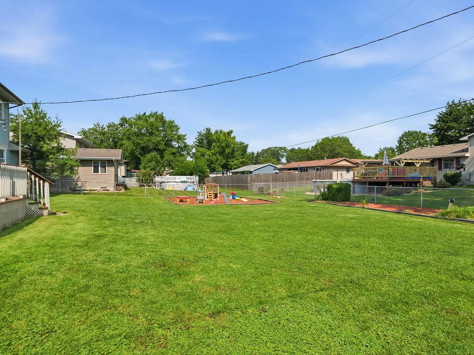 Fenced backyard with grassy area
