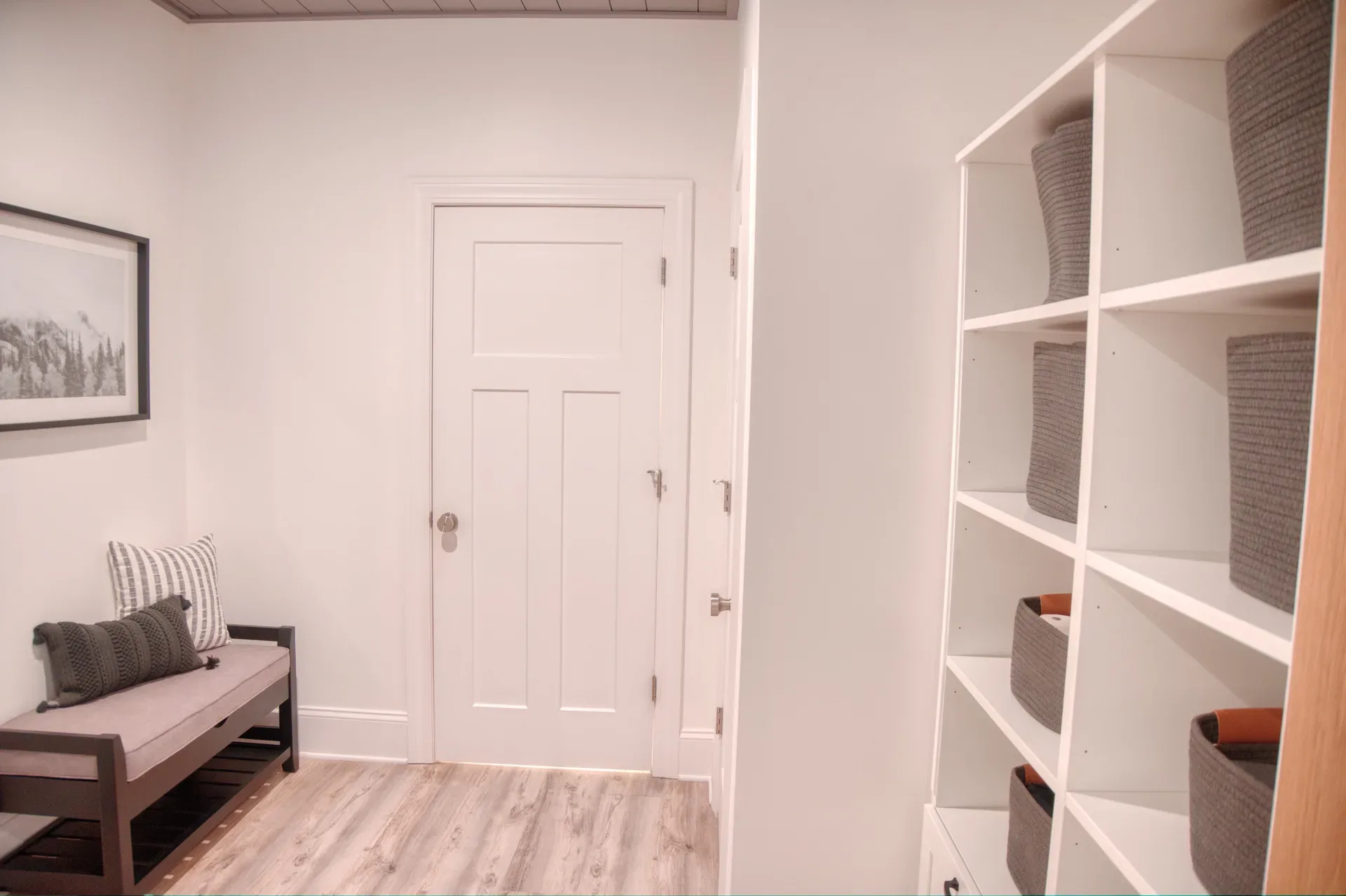 Mudroom entryway with white millwork and bench storage
