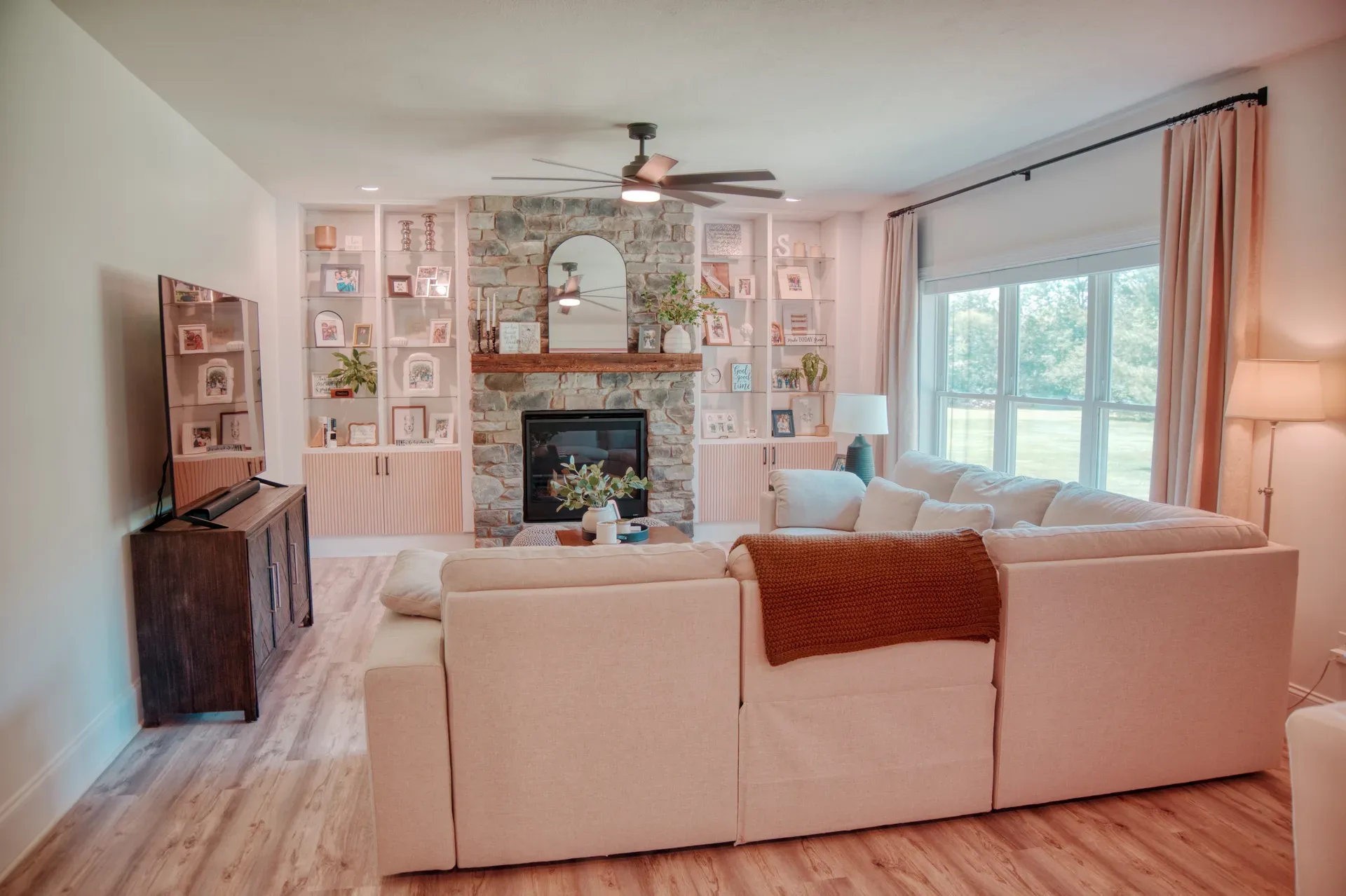 Great room with stone fireplace and reclaimed barn beam mantel