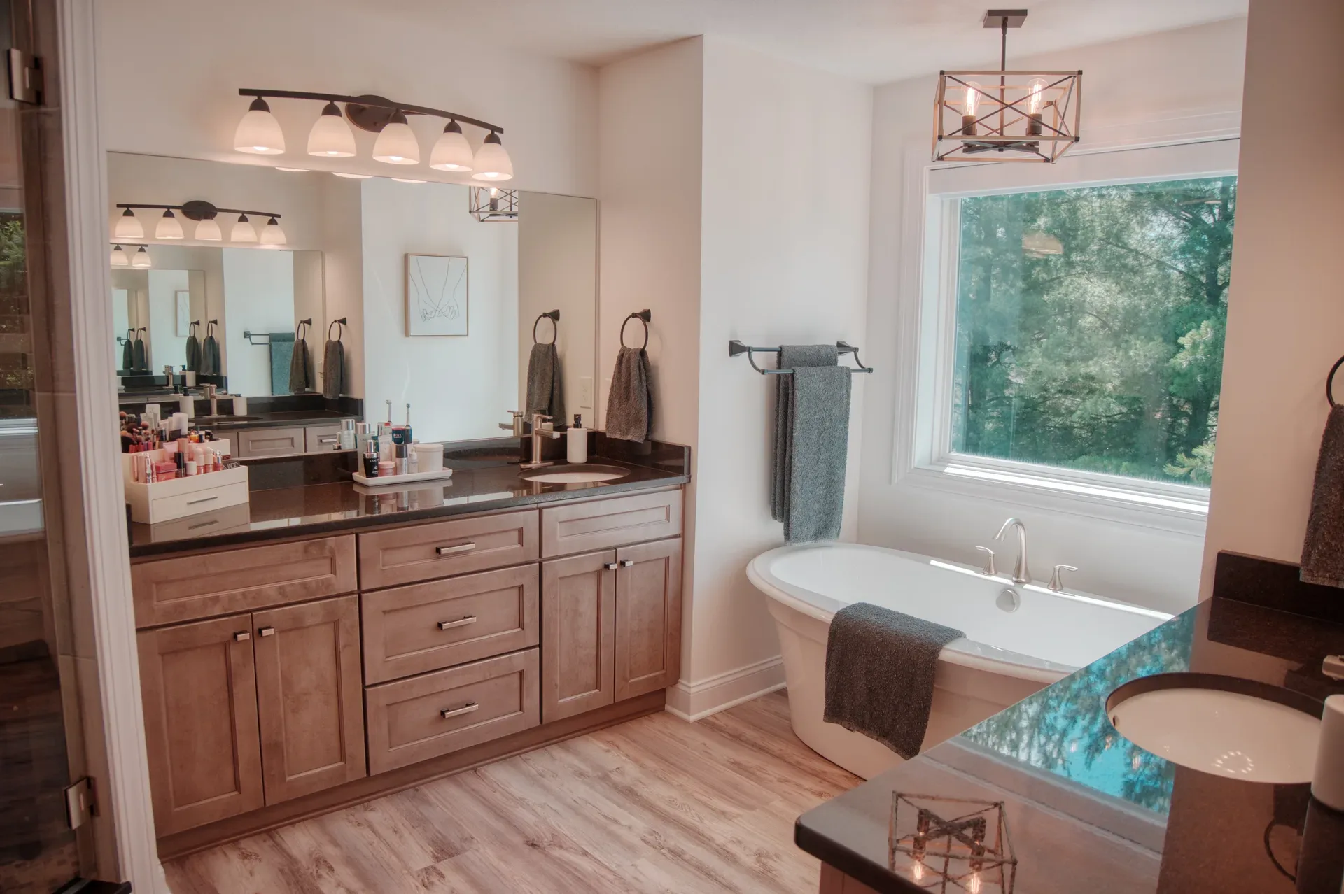 Master bathroom with soaking tub and stained wood vanity
