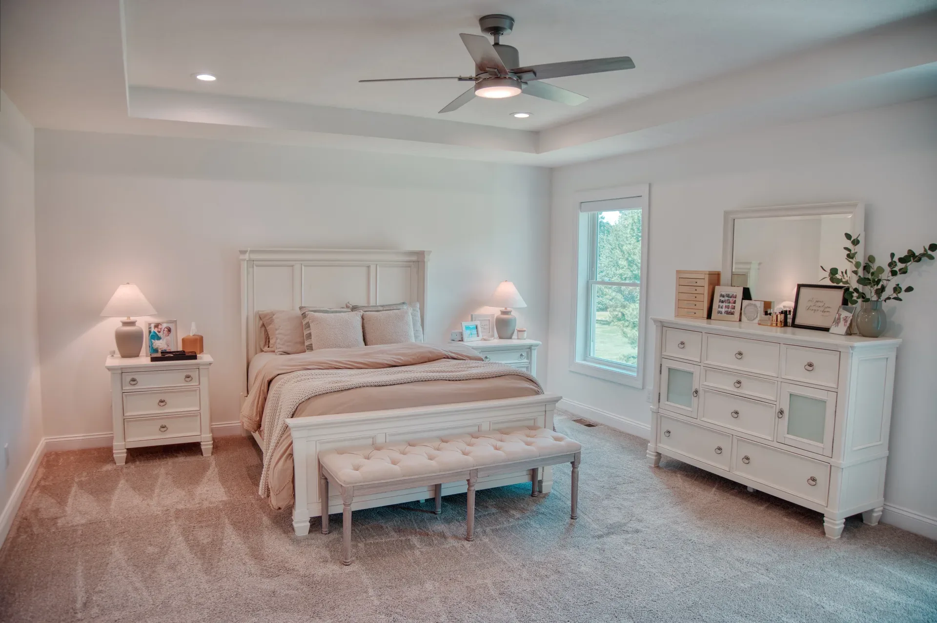 Primary bedroom suite with neutral tones and carpet
