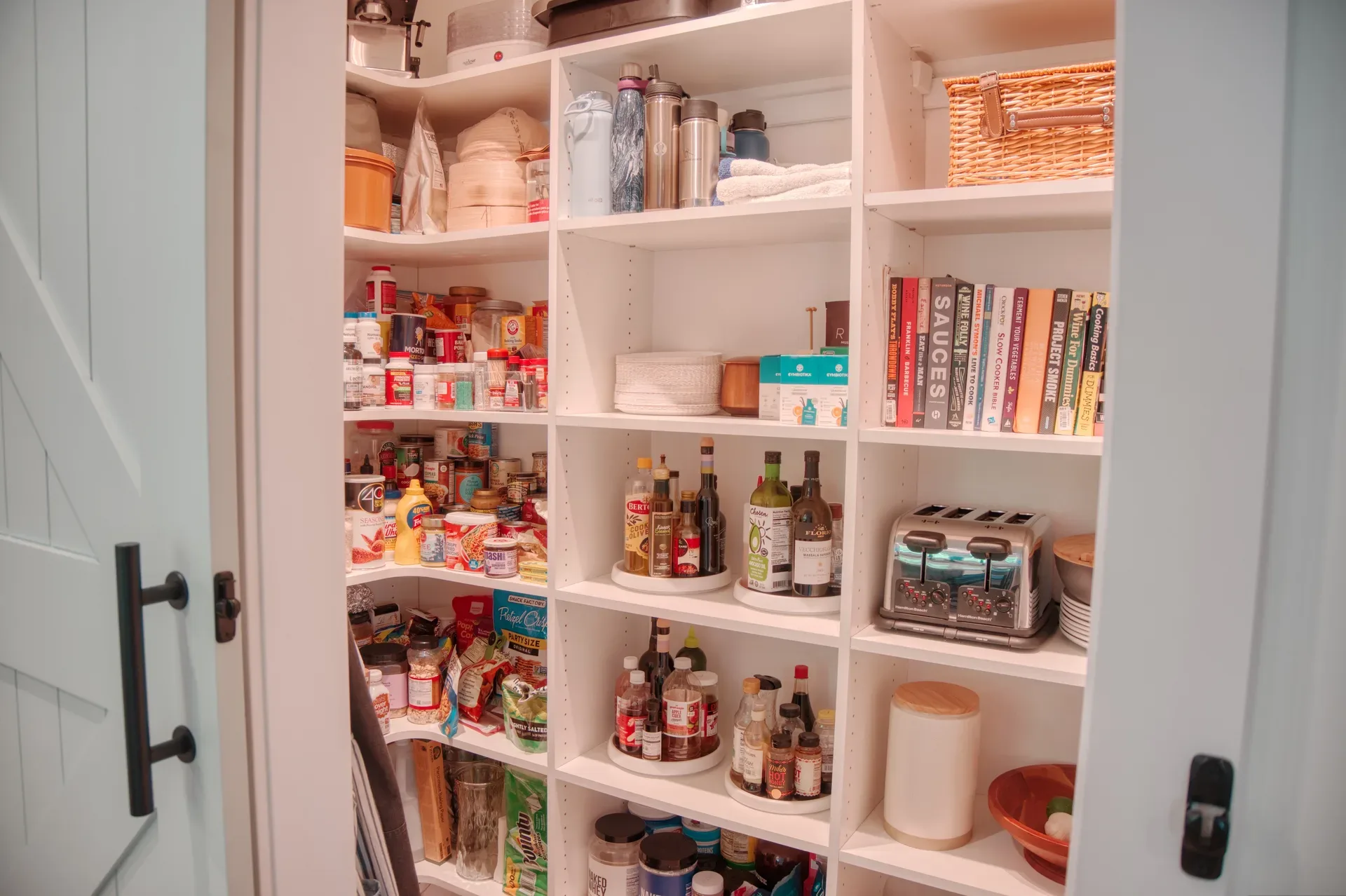 Walk-in kitchen pantry with custom built-in shelving