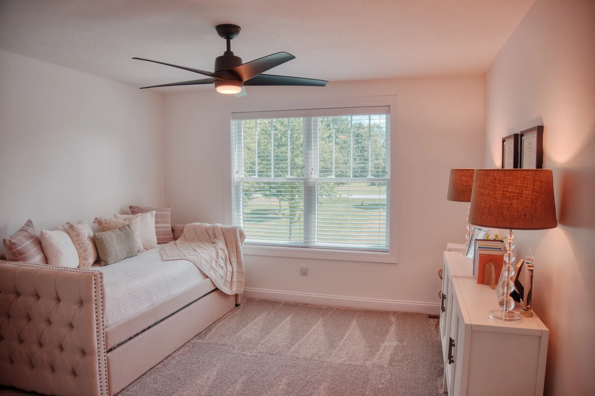Secondary bedroom with neutral walls, carpet, and natural daylight