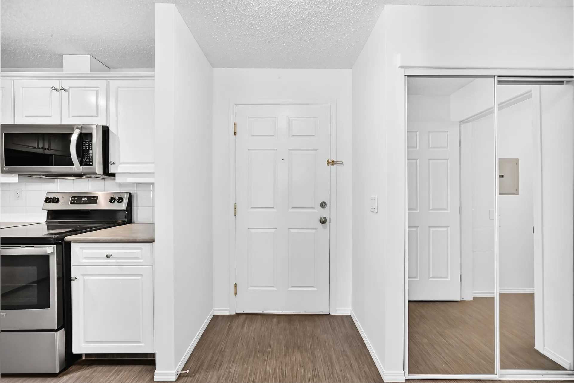 Entryway with kitchen visible on the left