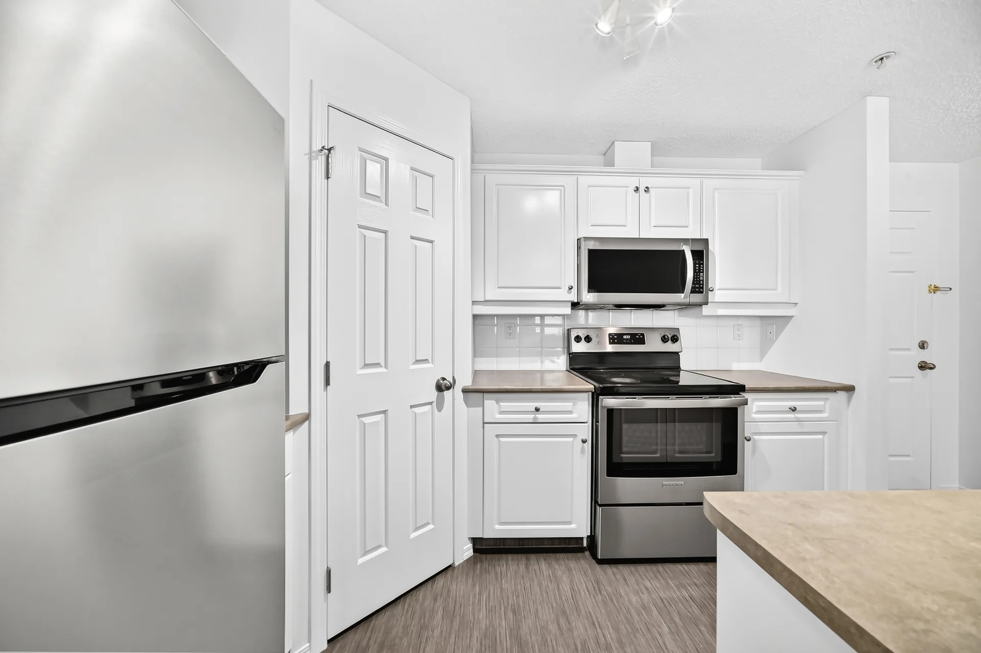 Kitchen with white cabinets and stainless steel appliances