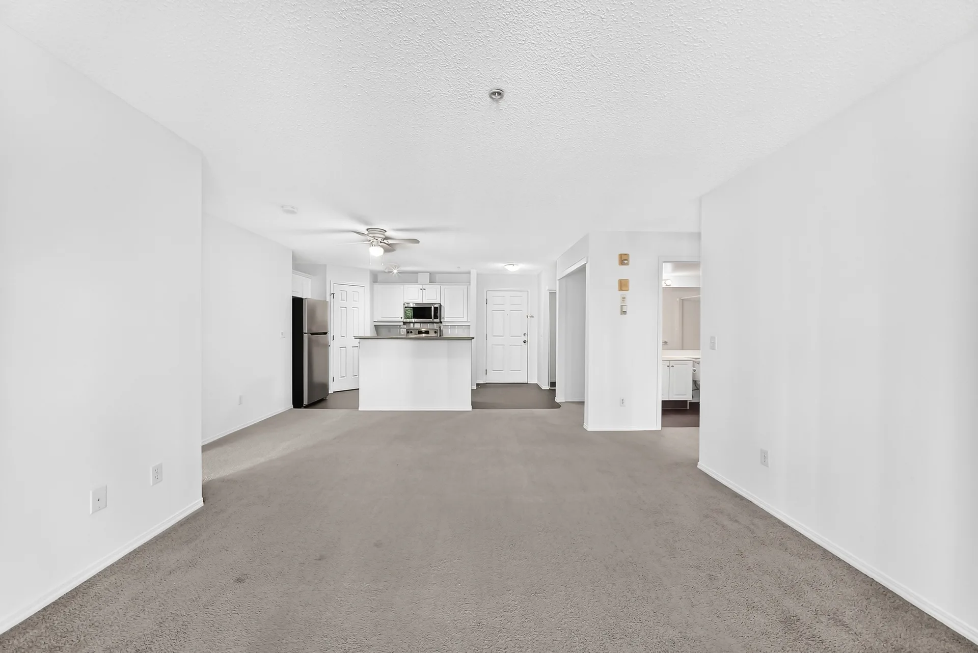 Open-concept living area toward kitchen